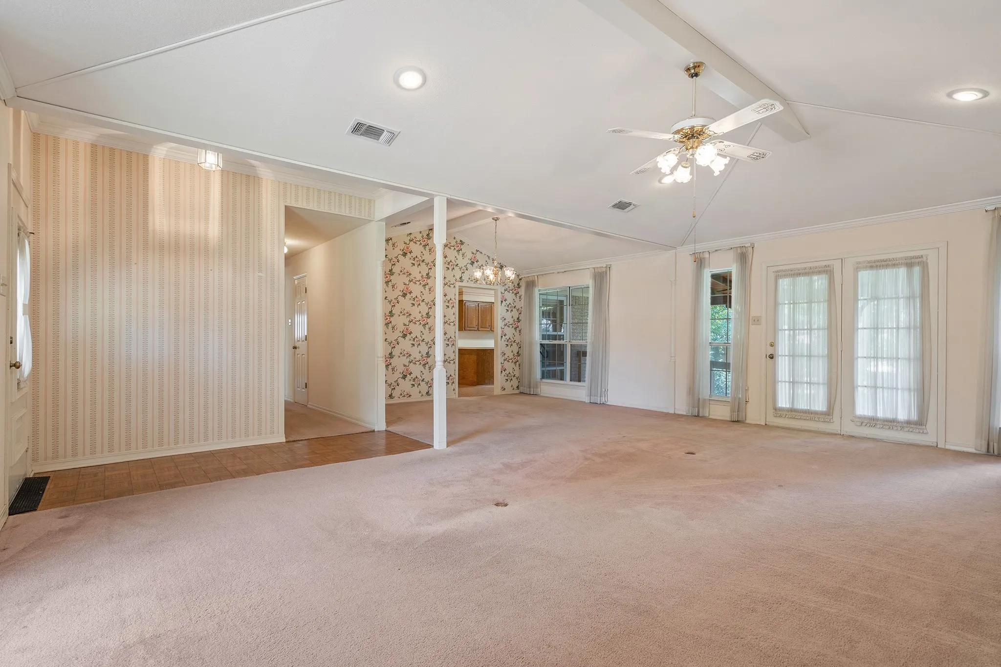Open living and dining, with french doors to the patio area