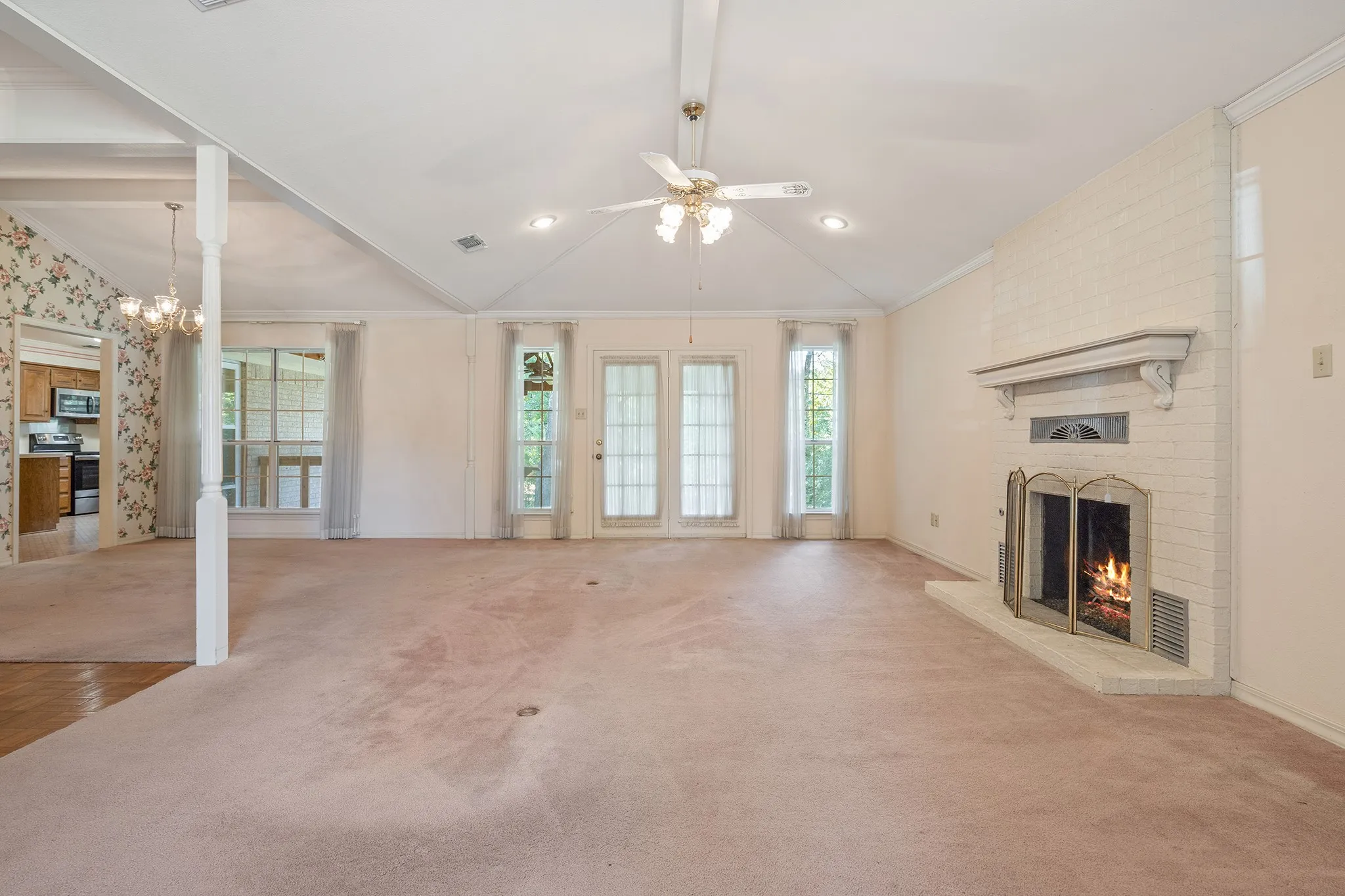 Open living and dining with window and french door views to back yard