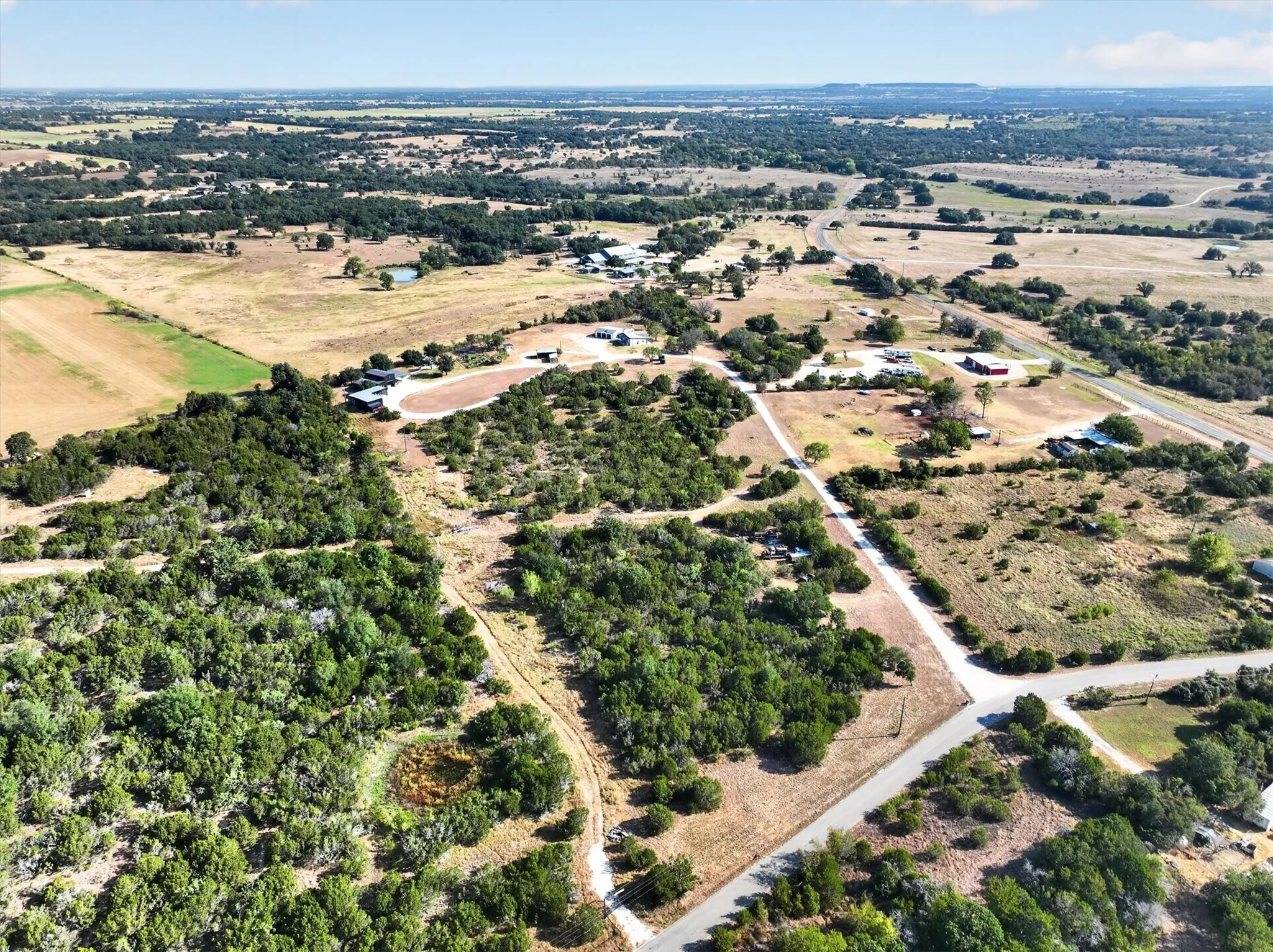 Expansive landscape featuring diverse tree coverage, open fields, and established roadways