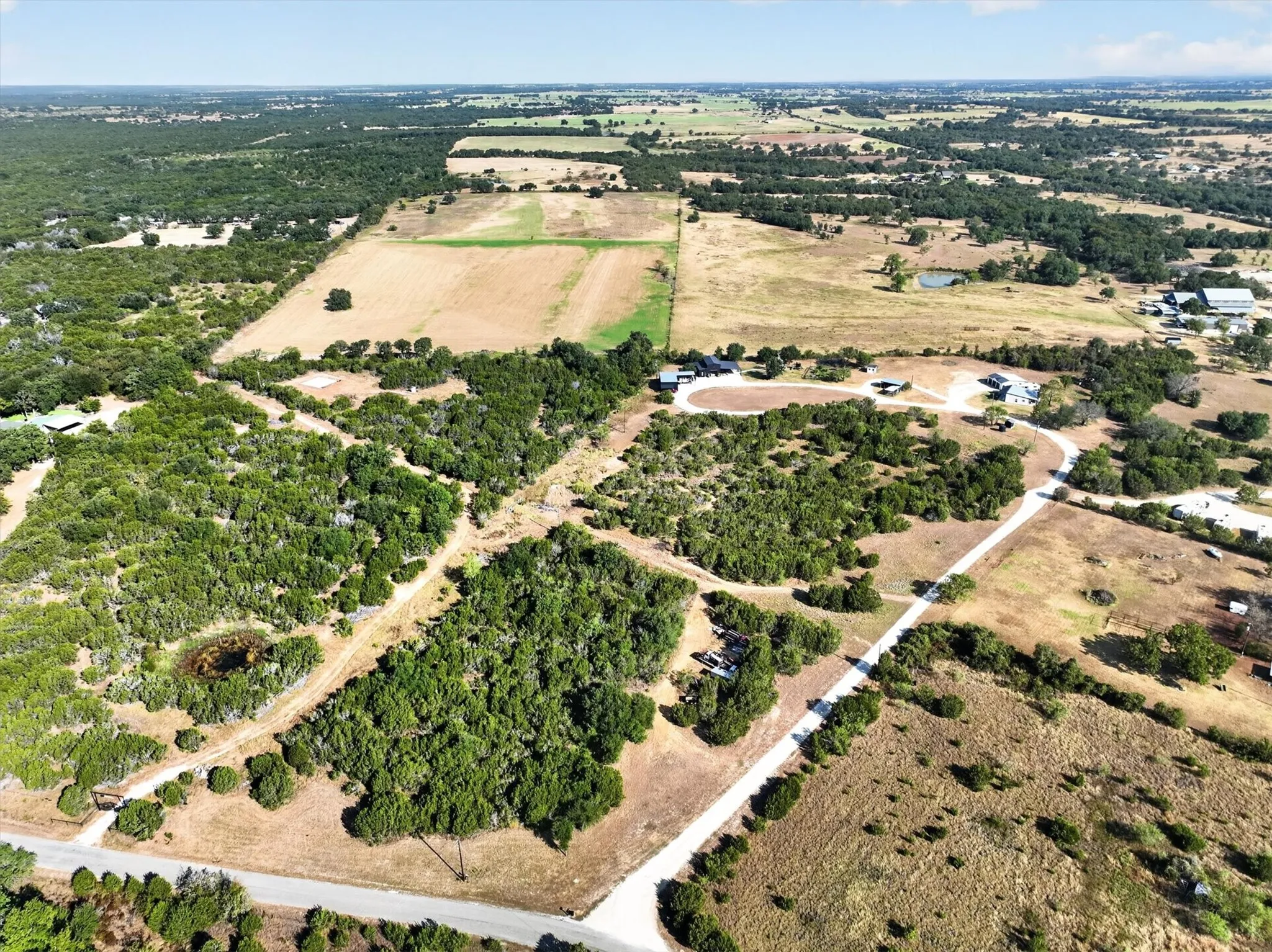 Expansive undeveloped land featuring a combination of dense woodlands and open fields
