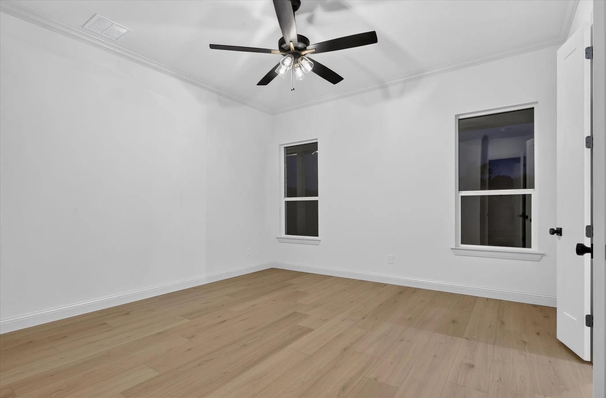 Recessed lighting, crown molding, wood-finish flooring, two windows, and a ceiling fan with integrated lighting