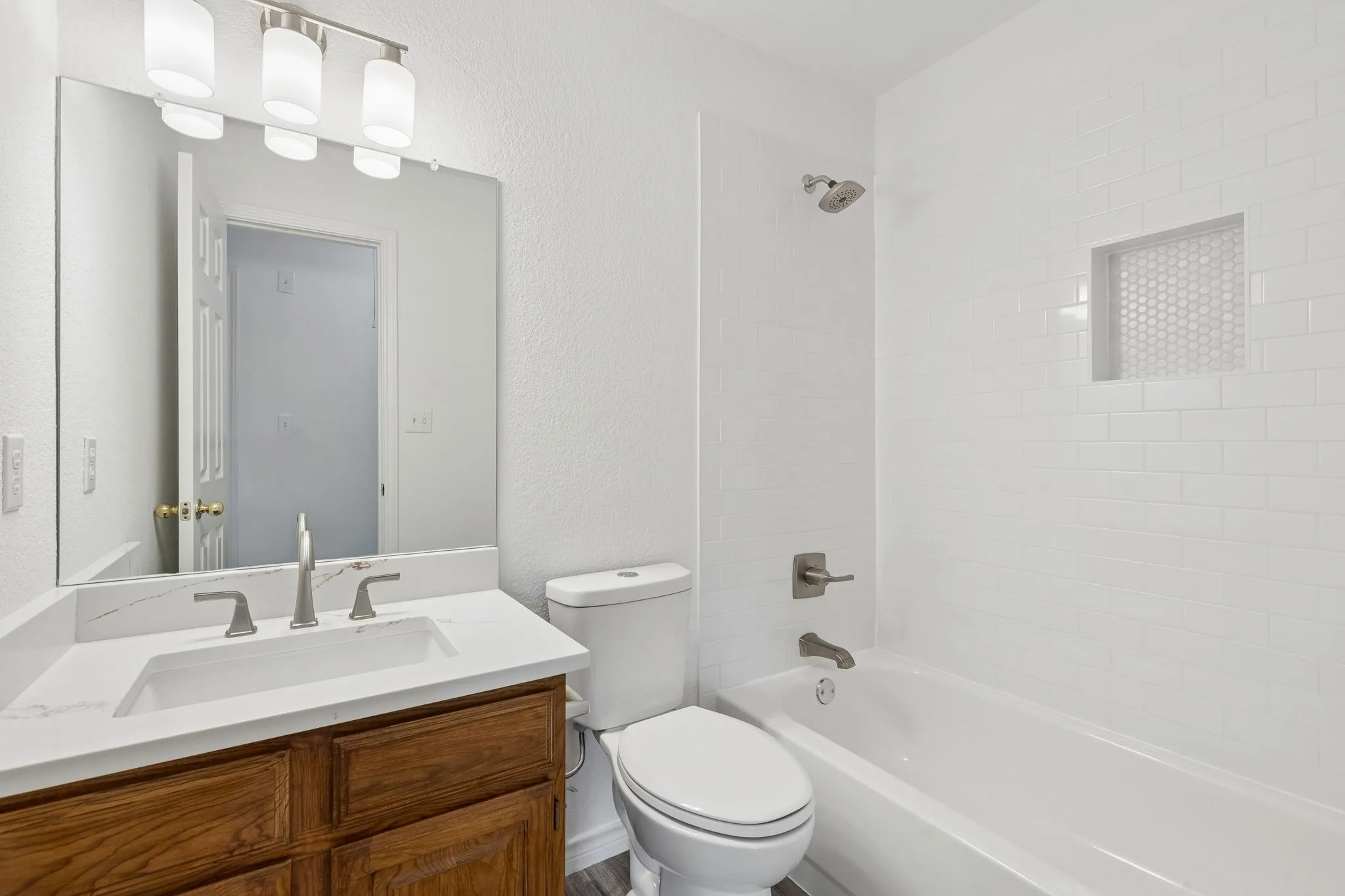 Hall Bath upstairs with new Quartz Countertops and shower tile with shampoo niche