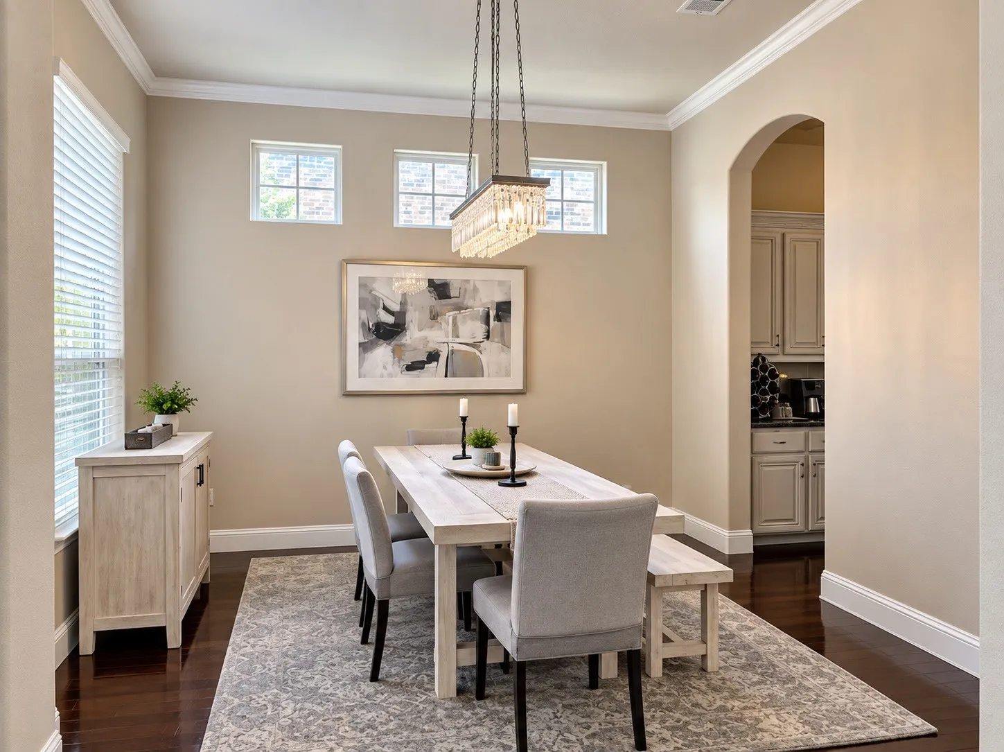 Recessed lighting, arched doorway, two rectangular windows, dark wood-finish flooring, and crown molding