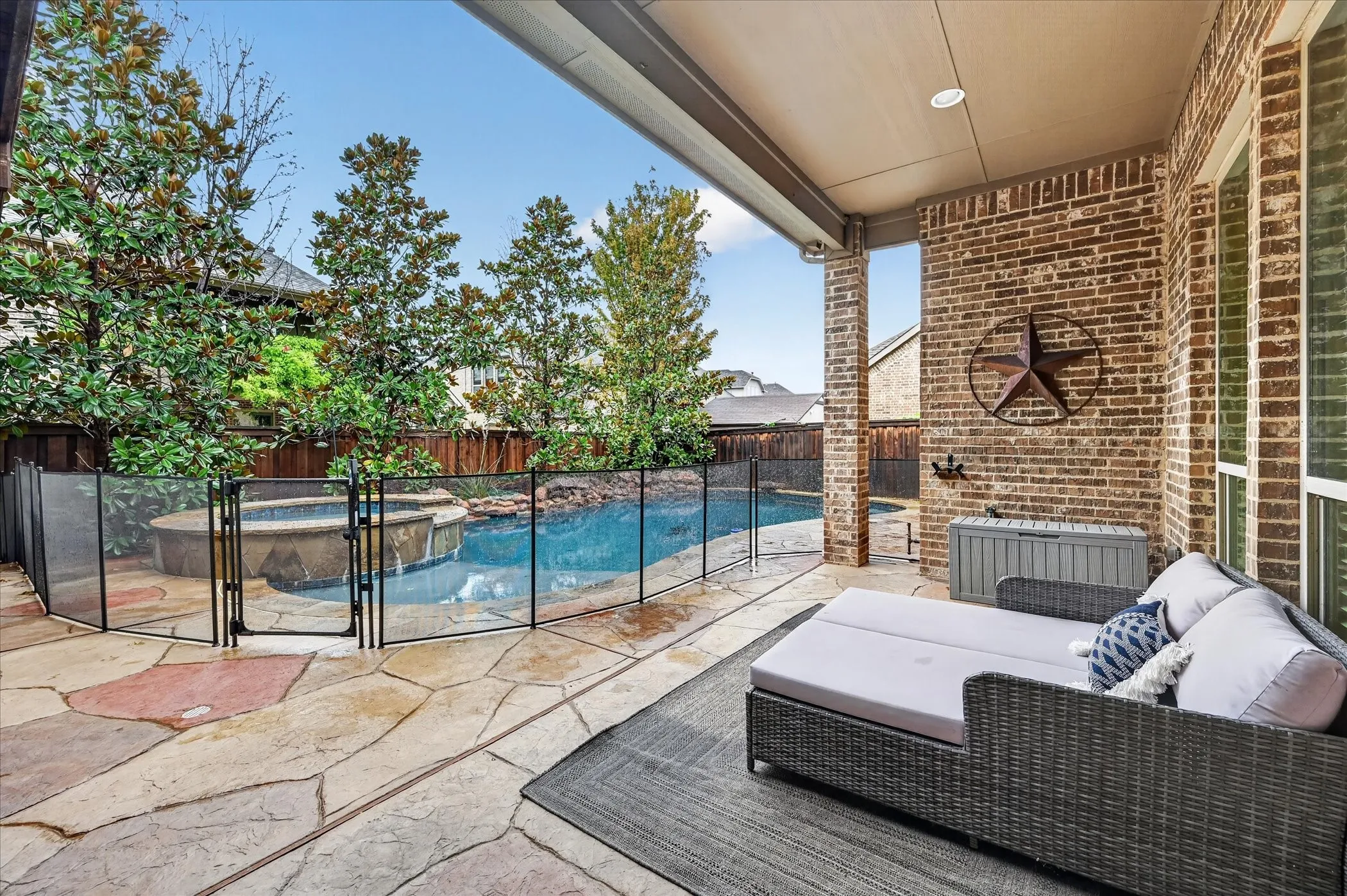 Covered patio with brick exterior, flagstone flooring, and recessed lighting