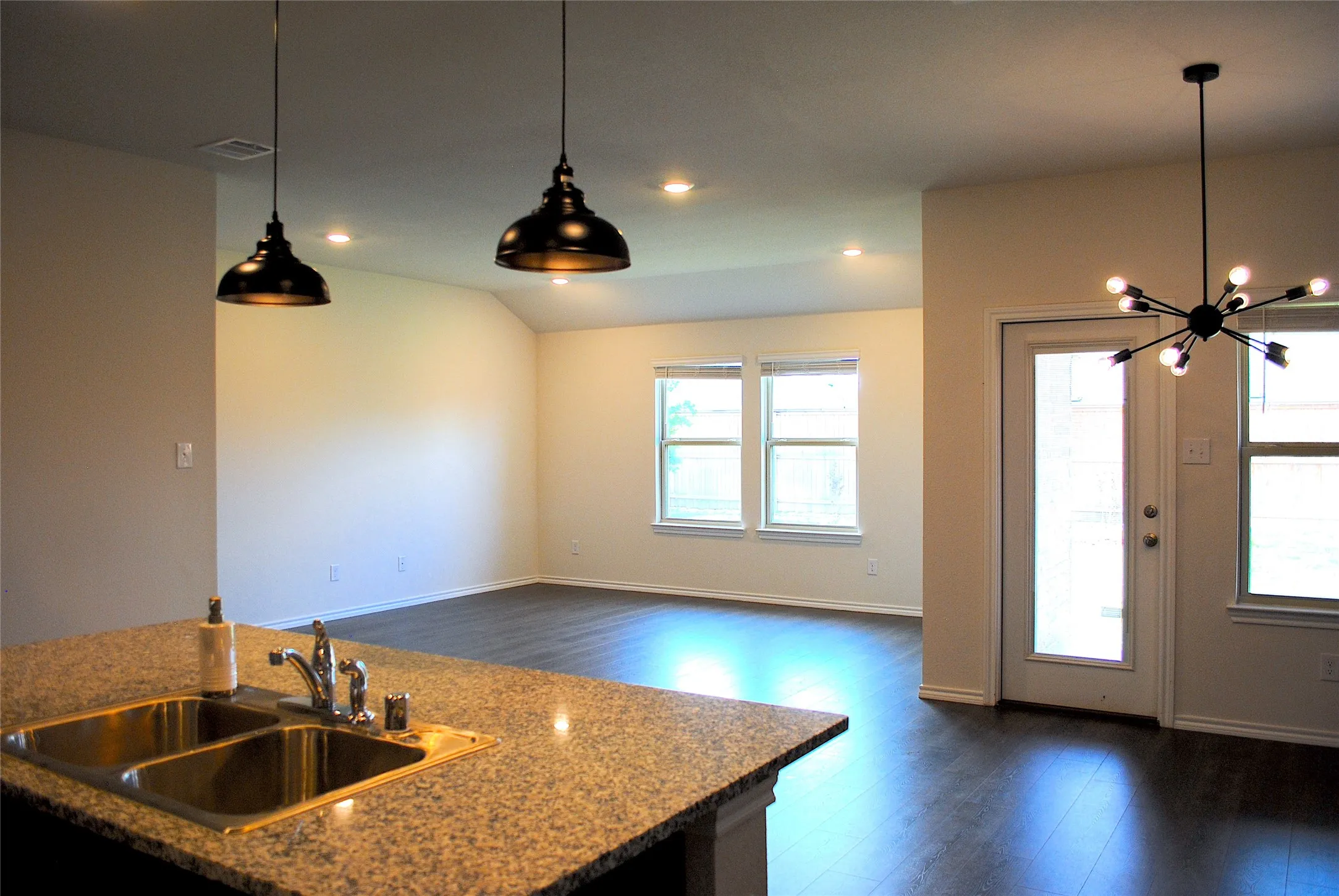 Kitchen island with a double basin sink and granular countertop
