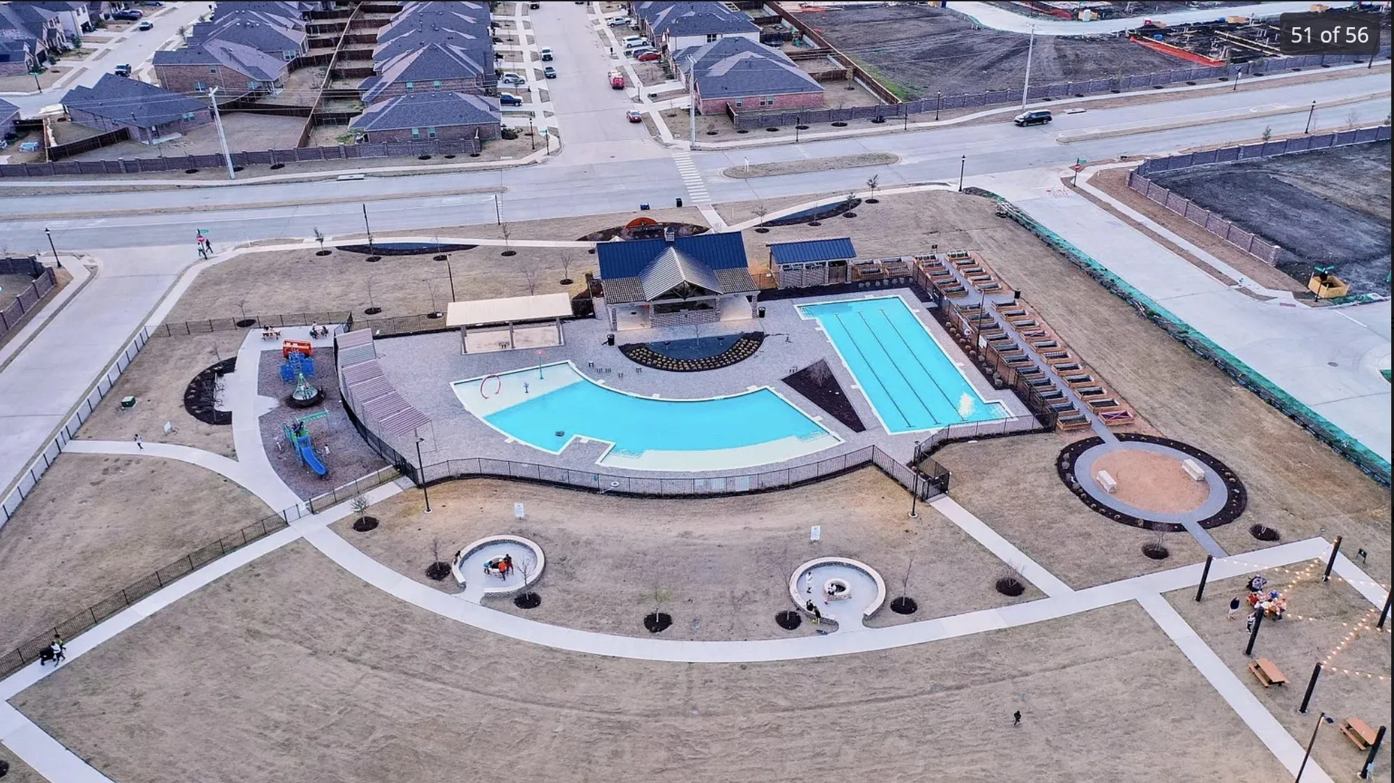 Community amenities featuring multiple swimming pools, a playground, paved walking paths, and a covered pavilion
