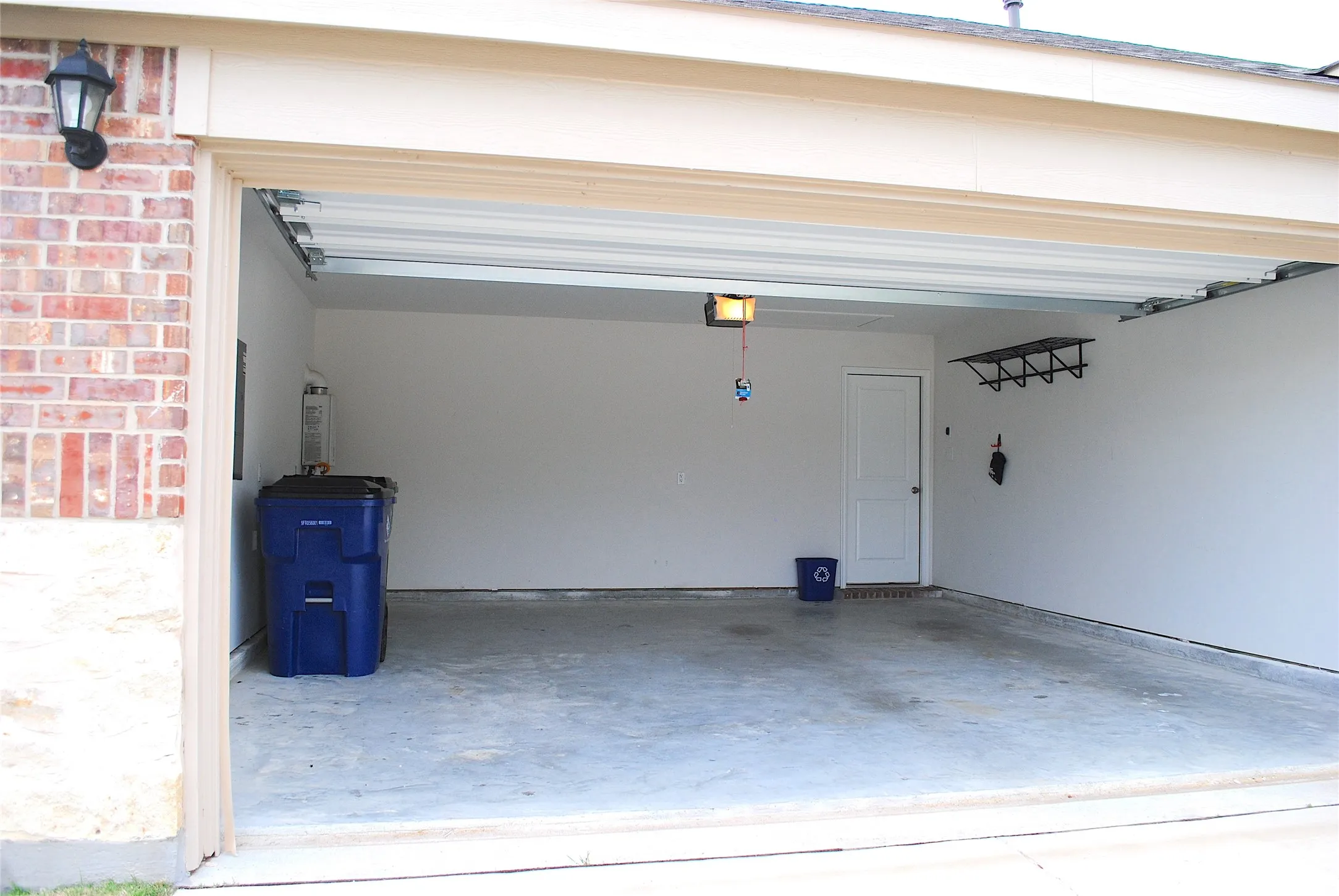 Attached lighting fixture, interior door, and concrete flooring