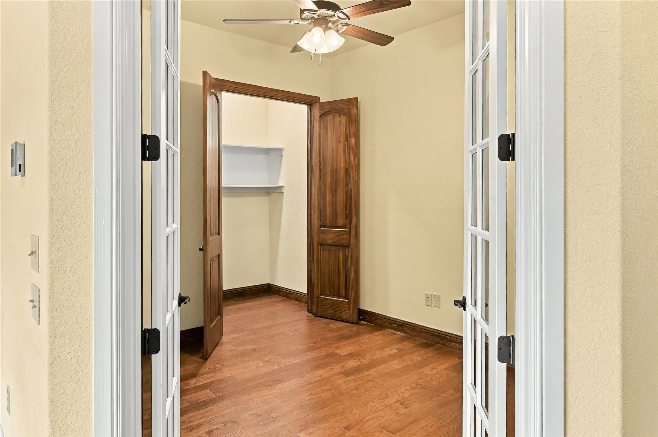 Office with large closet with shelves.