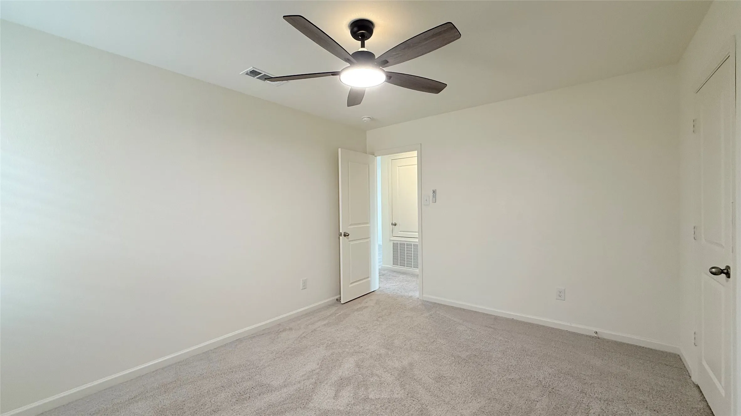 Neutral-toned walls complemented by plush carpeting