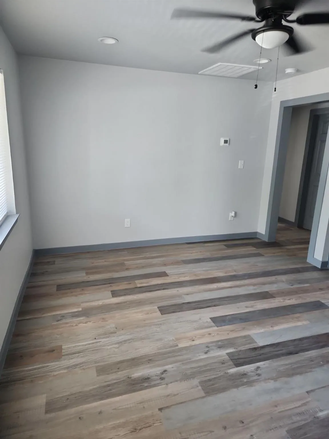 Wood-finish flooring, recessed lighting, and a ceiling fan with integrated light fixture