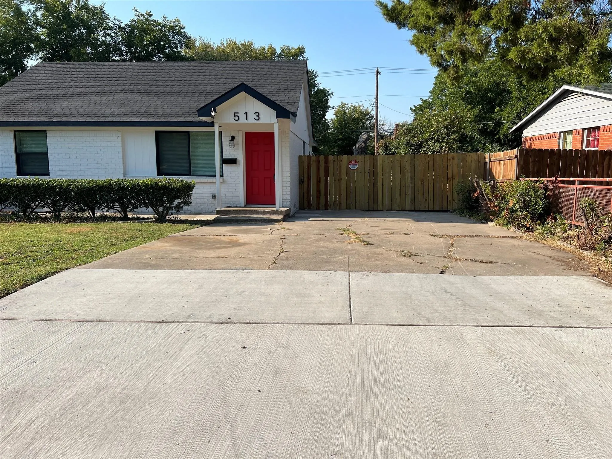 White brick exterior with a red front door