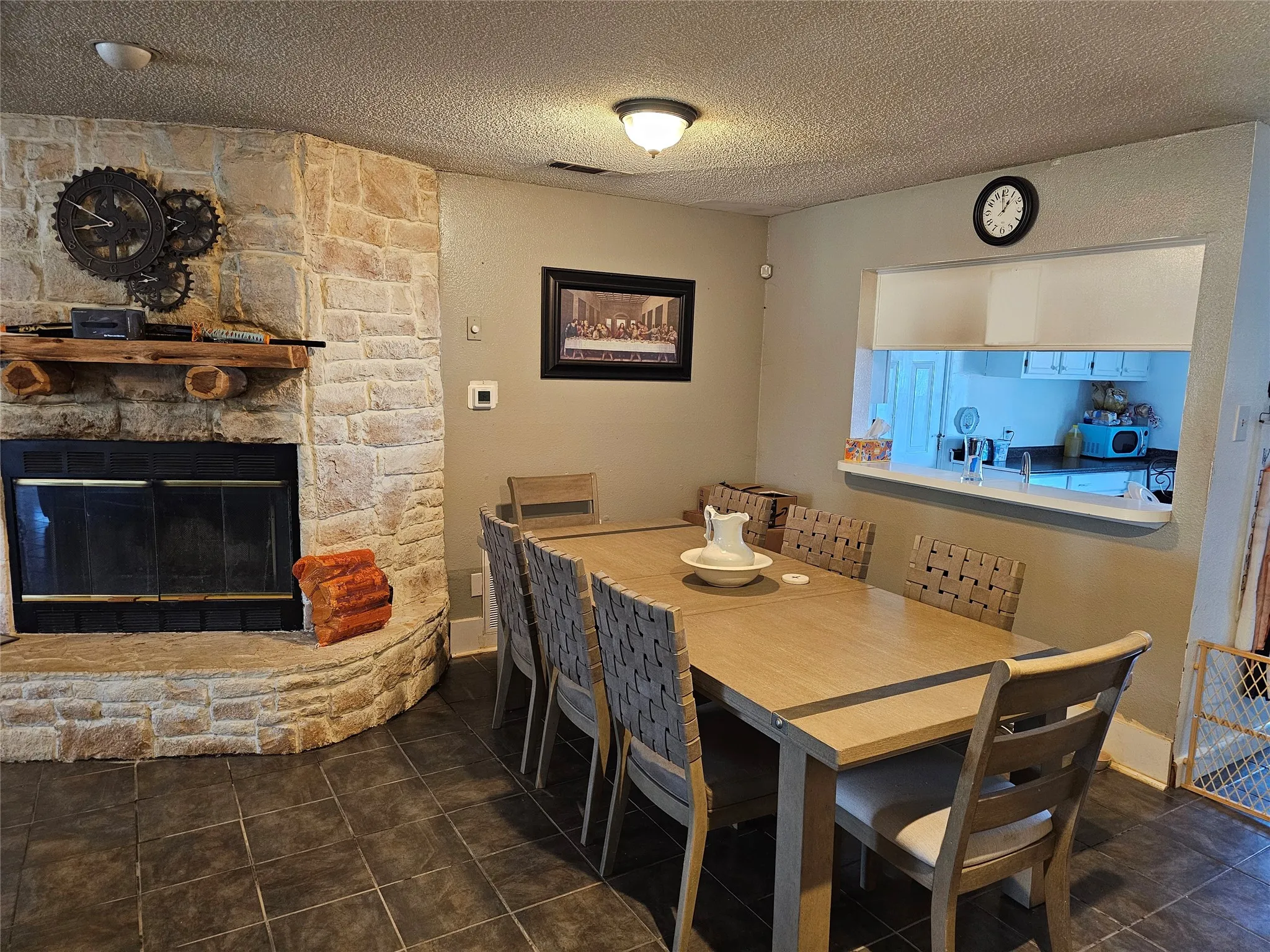 Stone-clad fireplace with a wood mantel