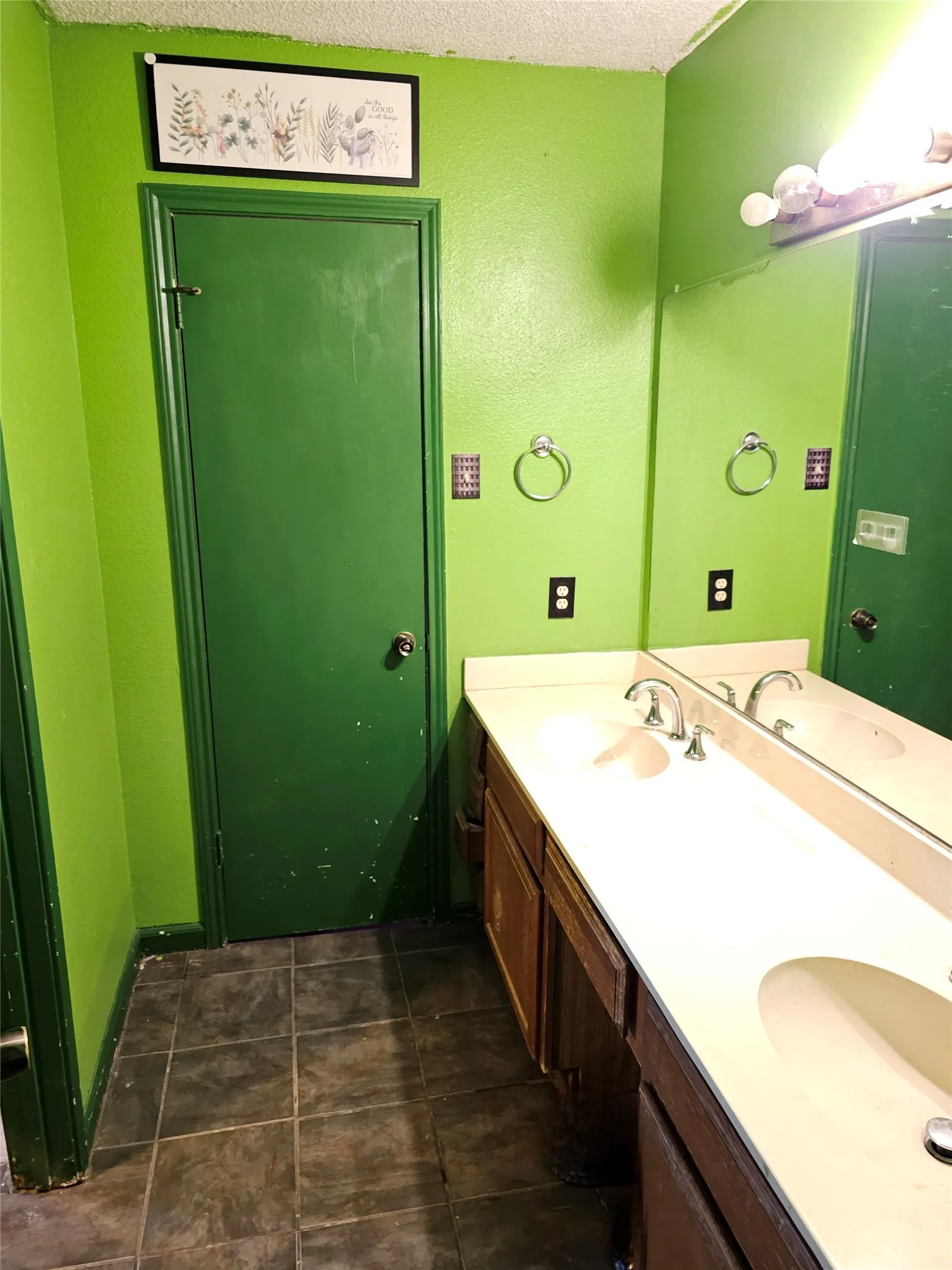 Double vanity with integrated sinks, chrome faucets, and a full-width mirror