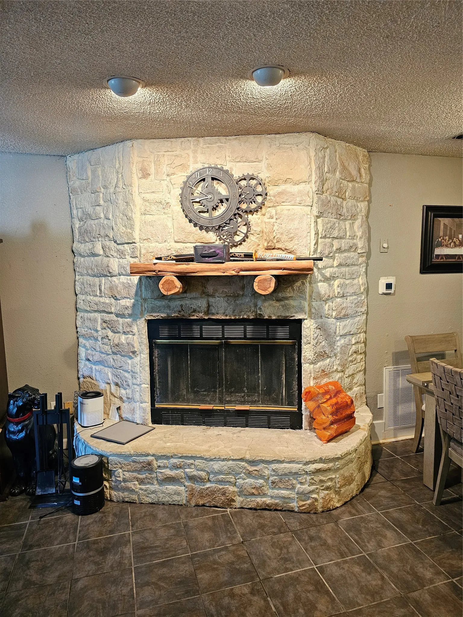 Stone-clad fireplace with a wood mantel