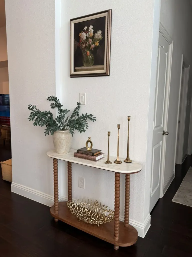 Dark wood-finish flooring, white painted walls, and white trim molding