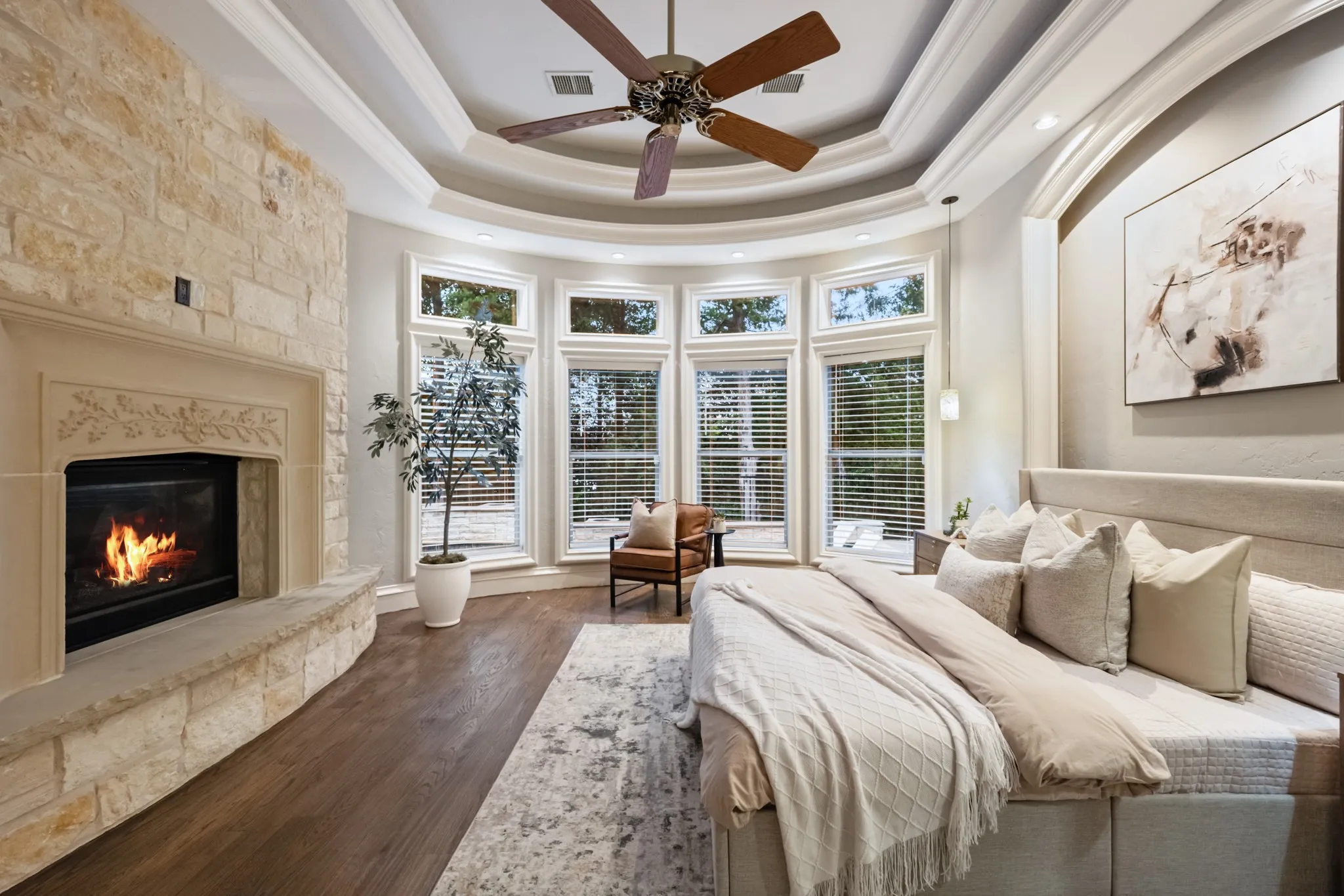 Primary bedroom with fireplace and pool views.
