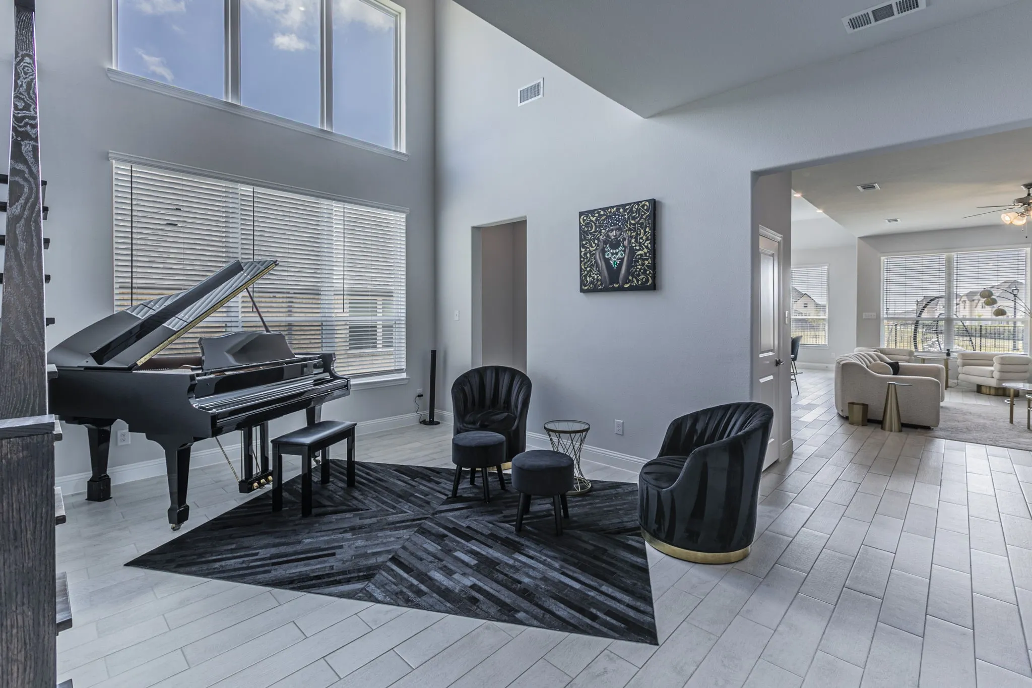 Sitting room with light Ceramic Tile flooring, a ceiling fan, and a high ceiling