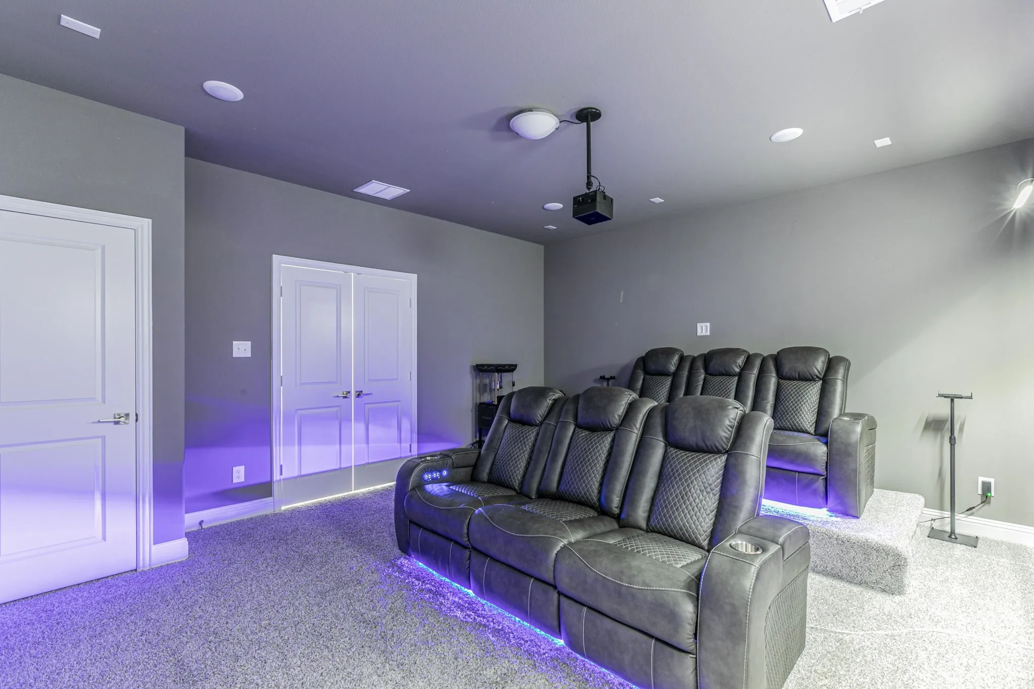Cinema featuring light colored carpet and recessed lighting