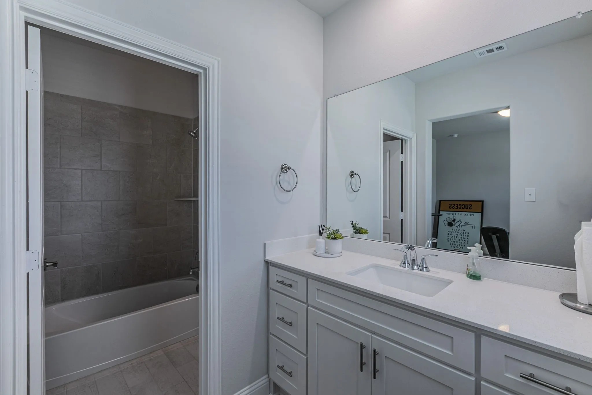 Bathroom with vanity and shower / washtub combination