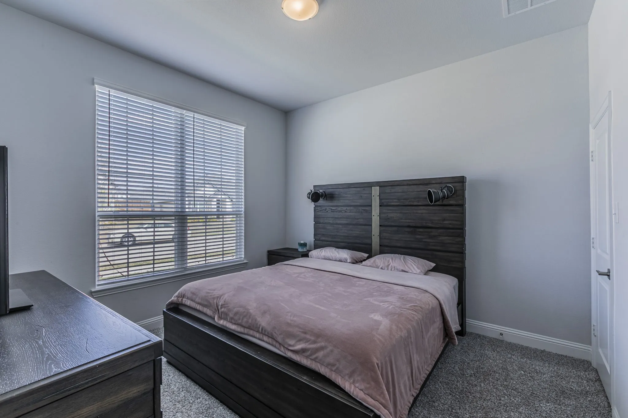 Carpeted bedroom with baseboards