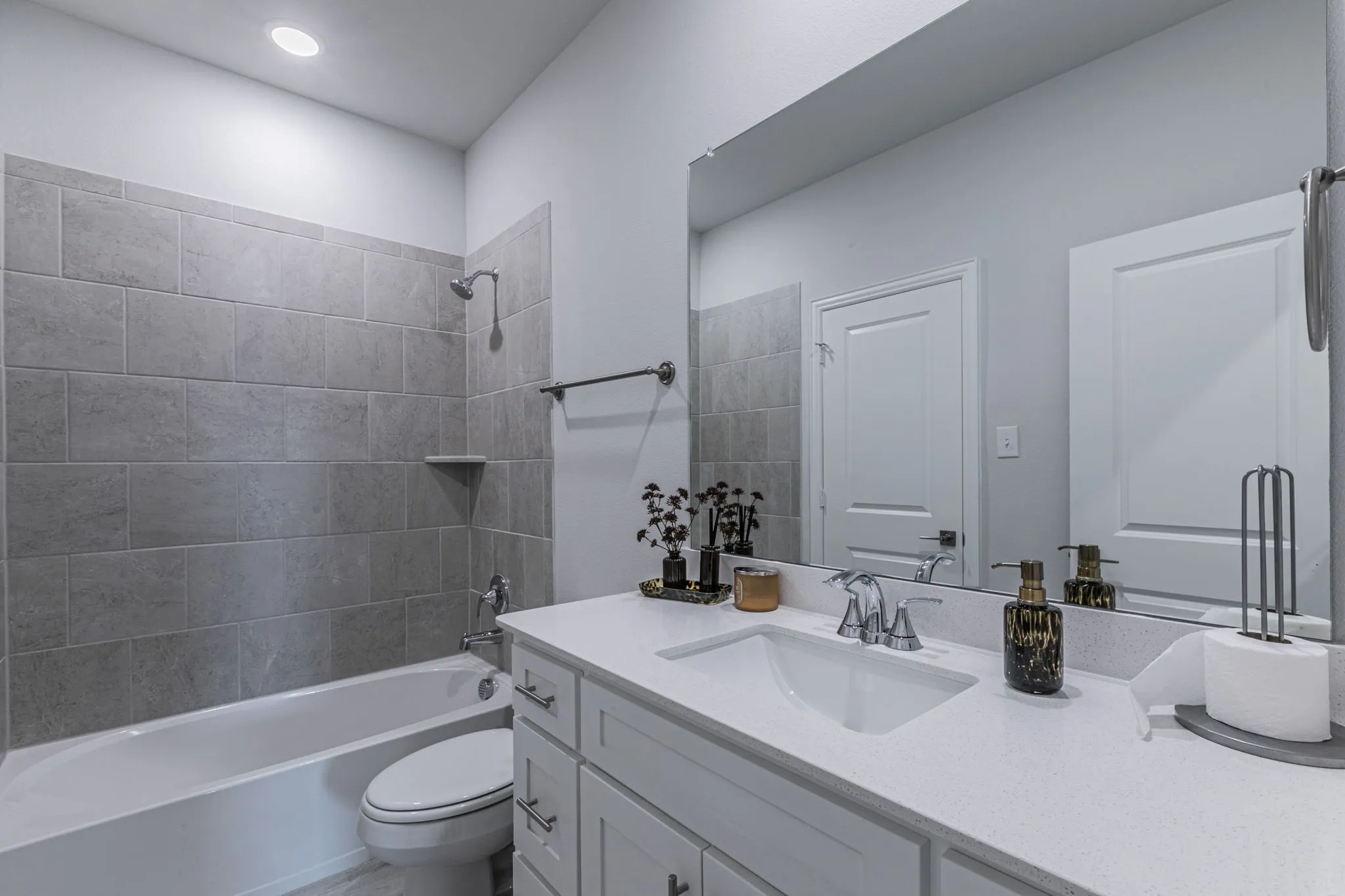 Bathroom with vanity and bathing tub / shower combination