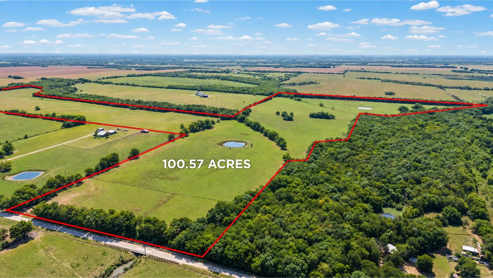 Expansive 100.57-acre property featuring open pastures, wooded areas, and two ponds