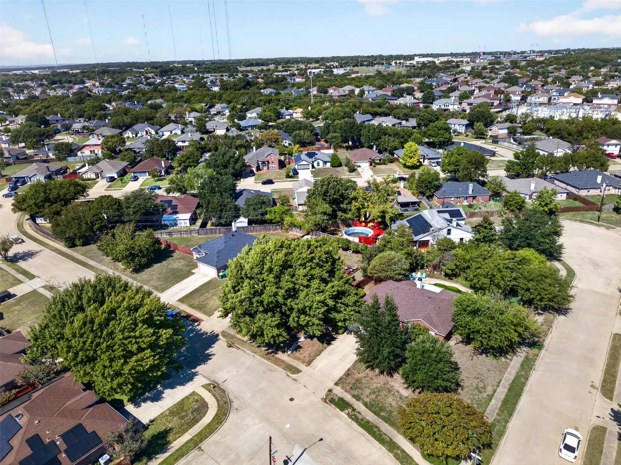Residential neighborhood with mature trees, established streets, and consistent housing styles