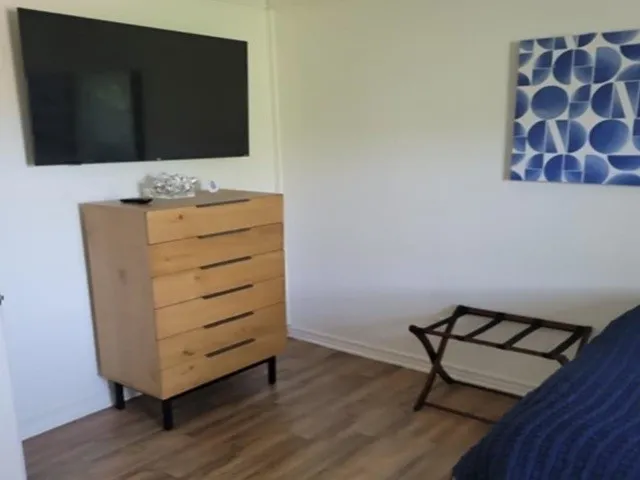 Wood-finish flooring with white baseboards