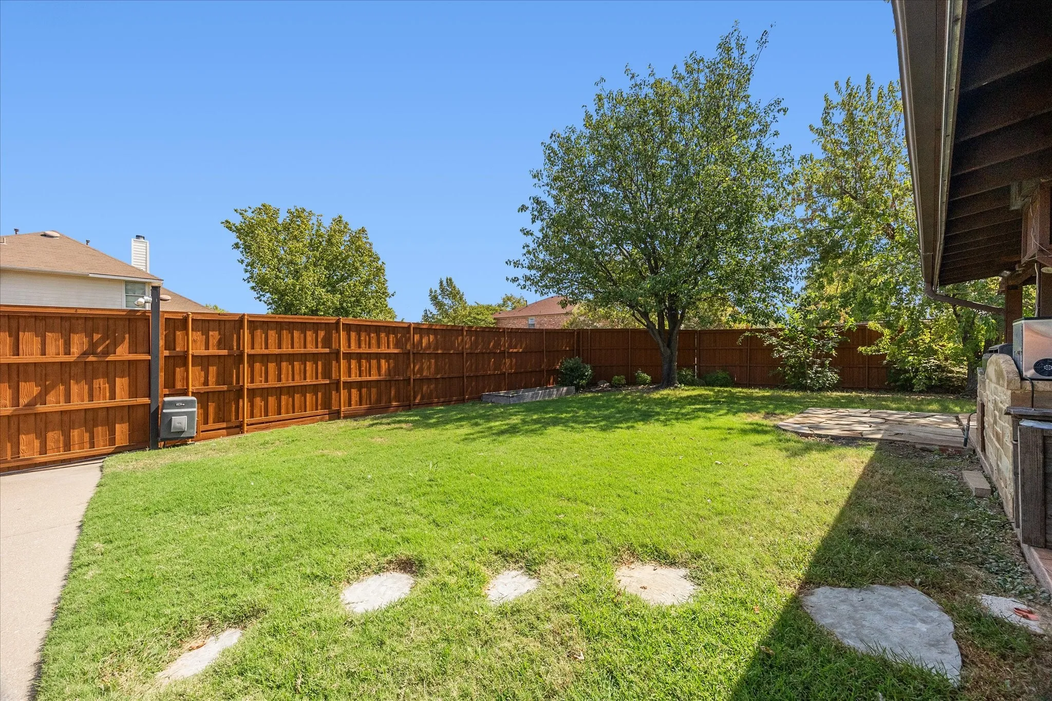 Enormous covered patio overlooks beautiful fenced backyard!