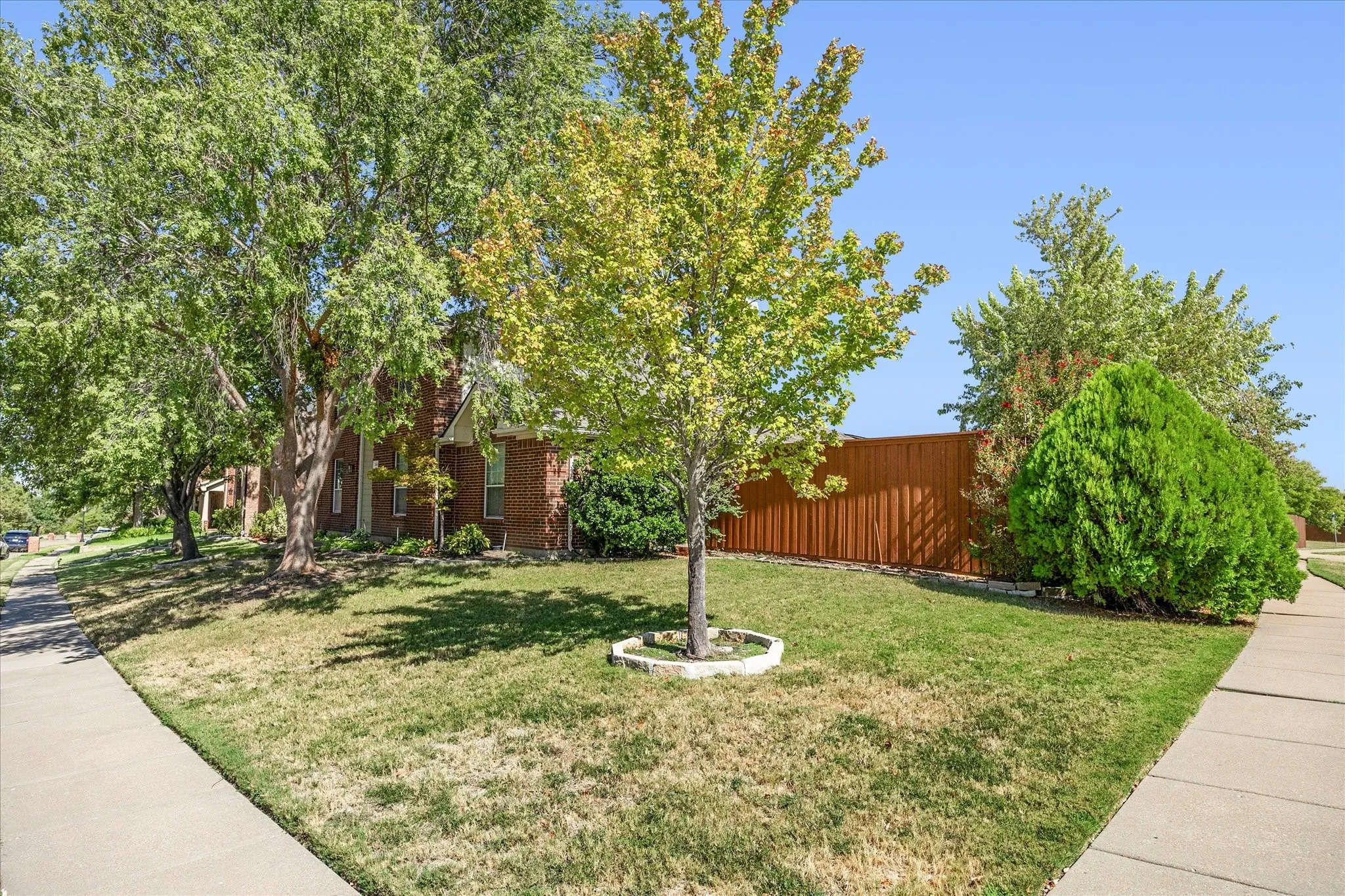 Mature trees adorn this lovely home's landscaping