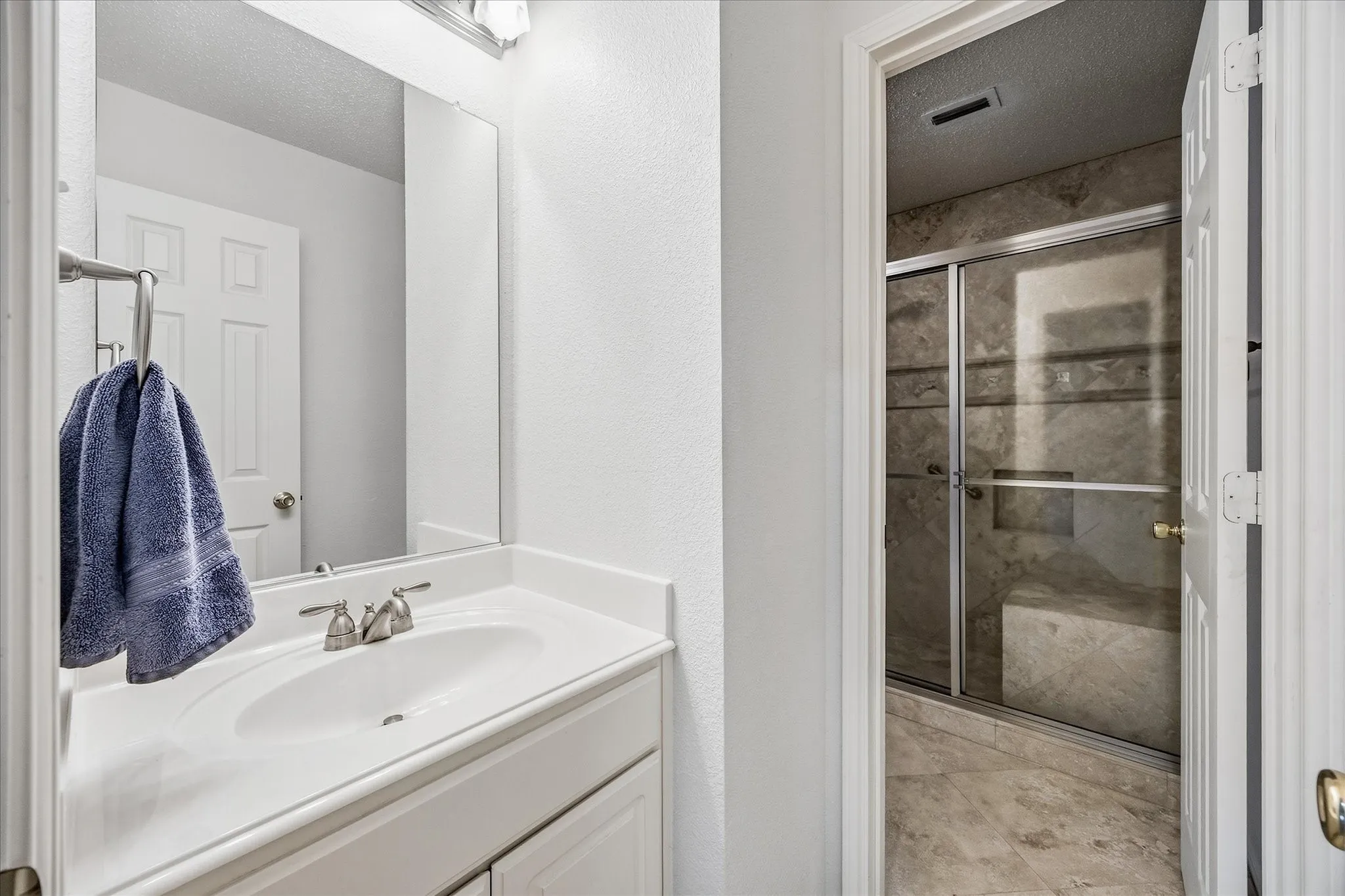 Auxiliary full bath opens onto auxiliary bedrooms