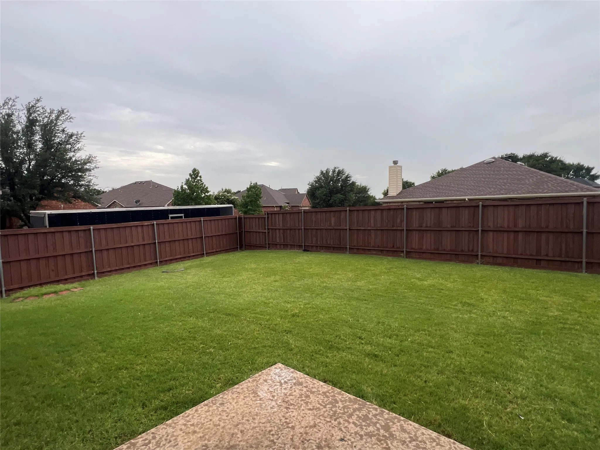 View of fenced backyard
