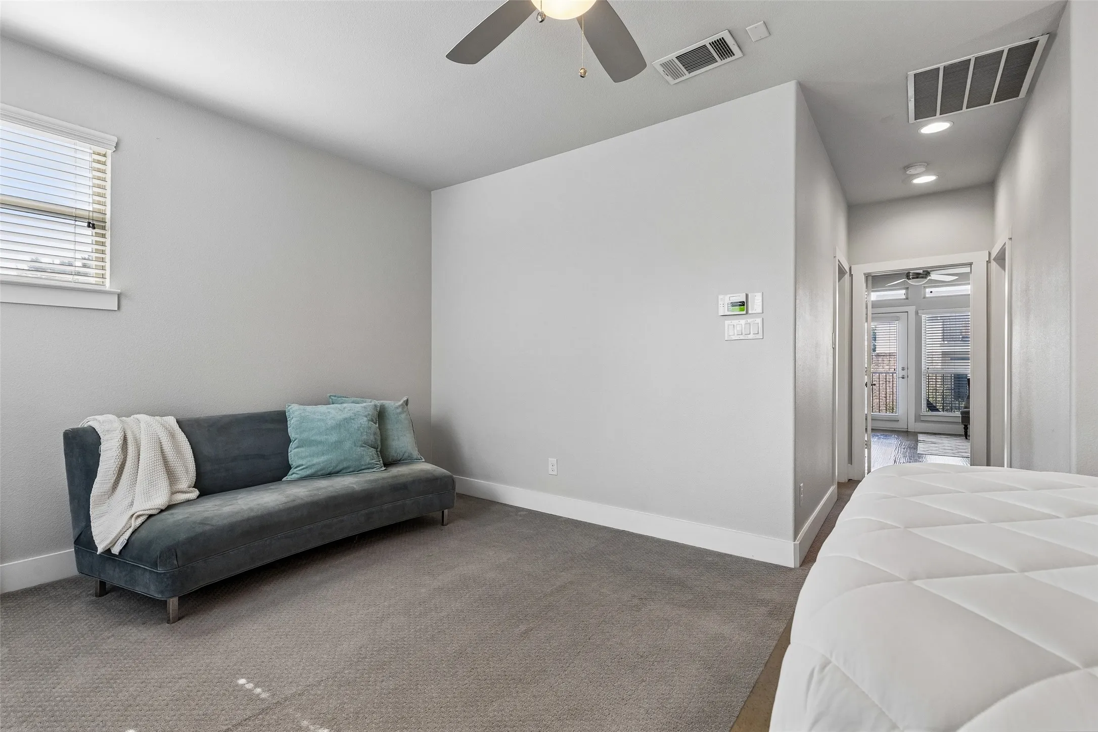 Carpeted room with a ceiling fan, recessed lighting, and a white window with blinds