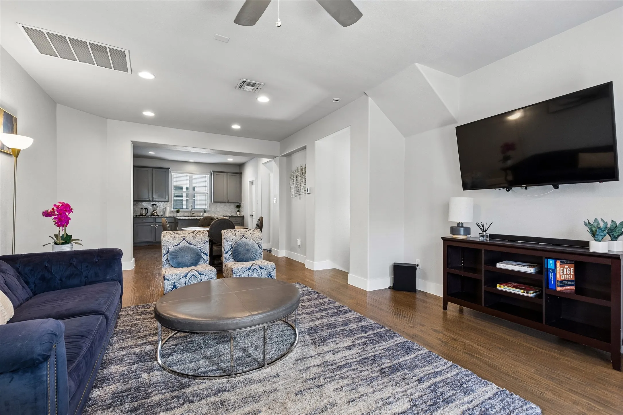 Hardwood-finish flooring throughout, recessed lighting, ceiling fan, and an open concept layout with a kitchen