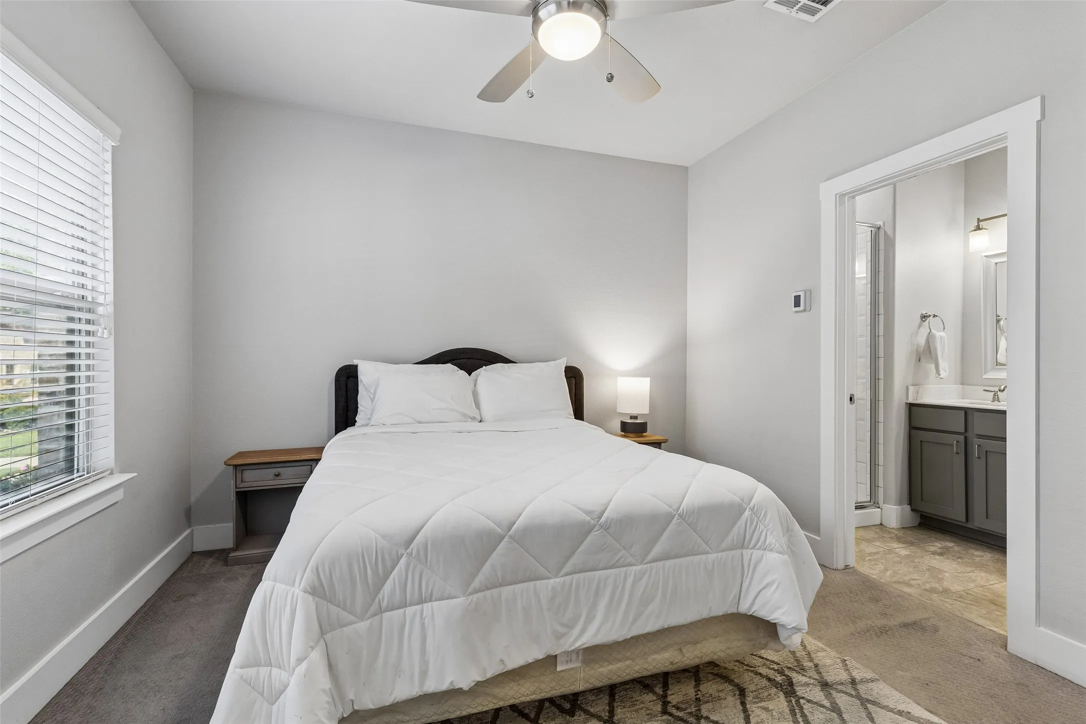 Recessed lighting, ceiling fan, window with blinds, private bathroom access, and carpet flooring