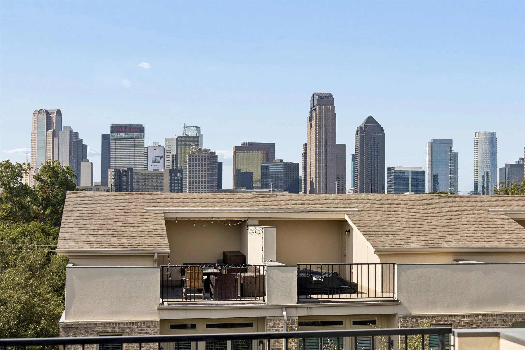 Rooftop terrace with metal railing, offering expansive skyline visibility
