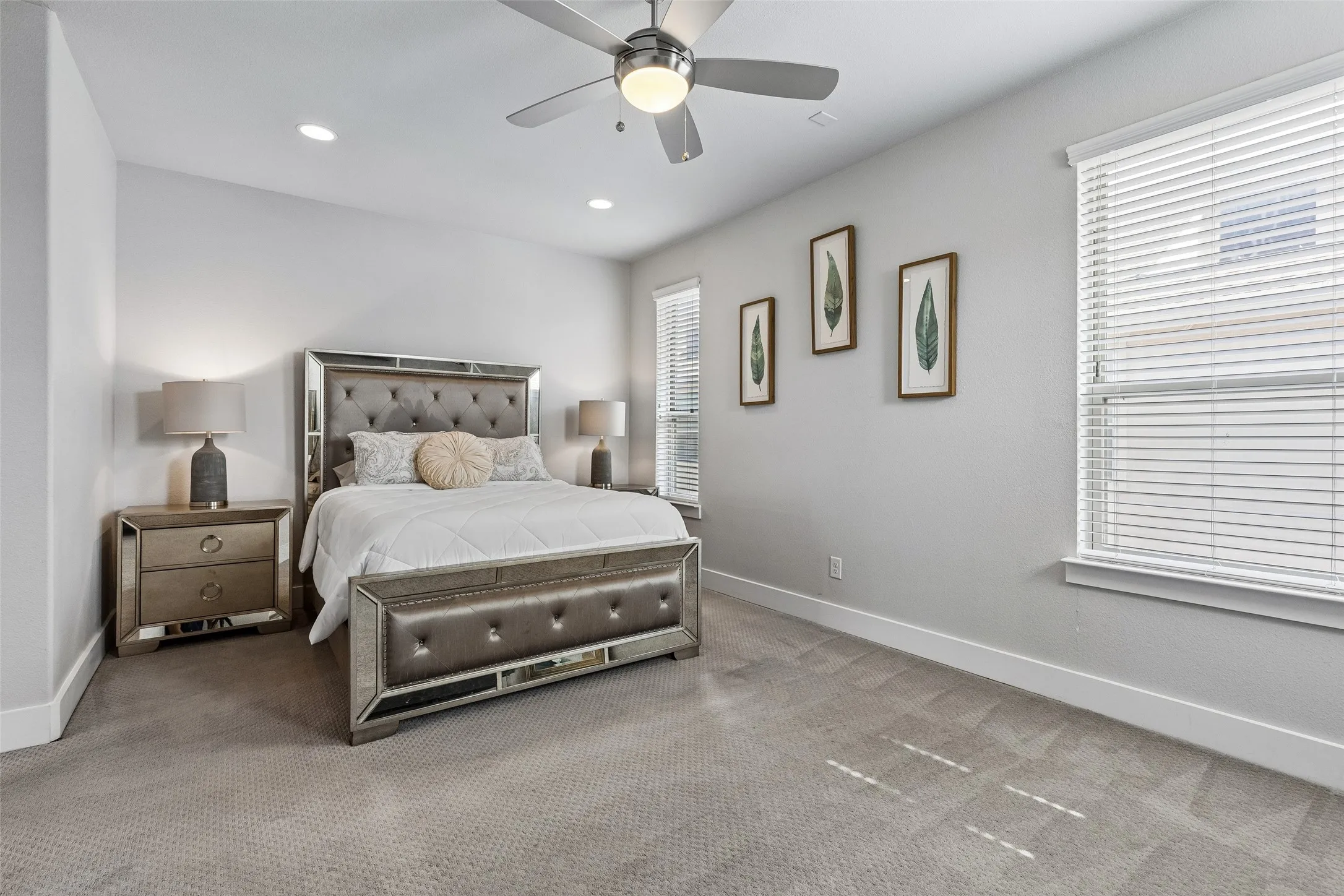 Recessed lighting, ceiling fan with integrated light, two windows with blinds, and light gray wall paint