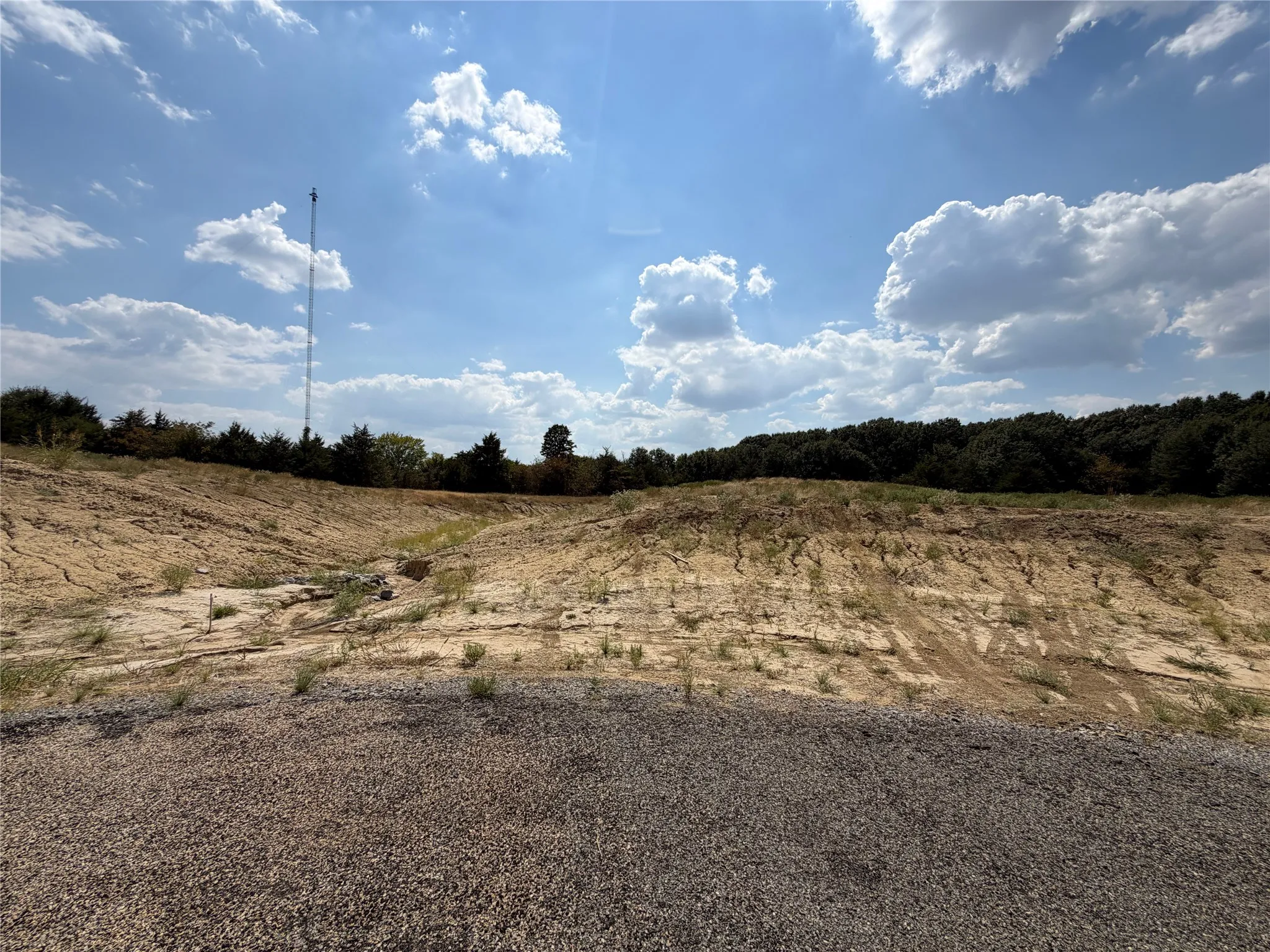 Expansive undeveloped land featuring varied terrain and mature tree lines