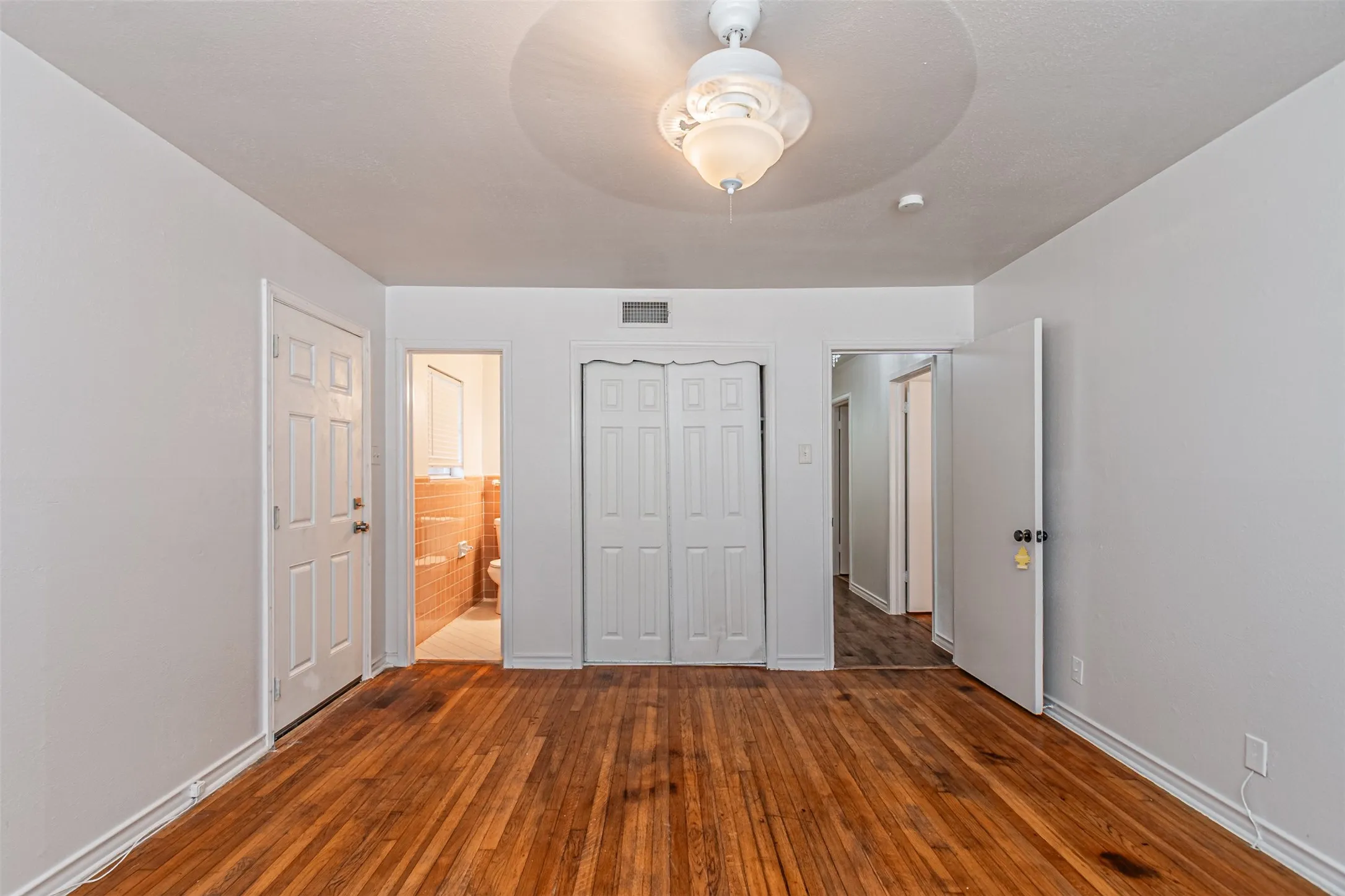 Hardwood flooring, recessed lighting, ceiling fan, bi-fold closet doors, and panel doors