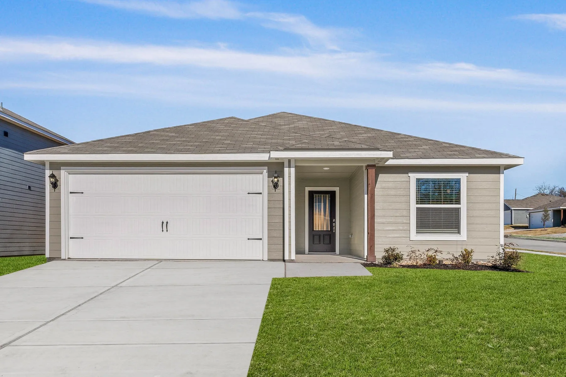 Single story home featuring a front lawn and a garage
