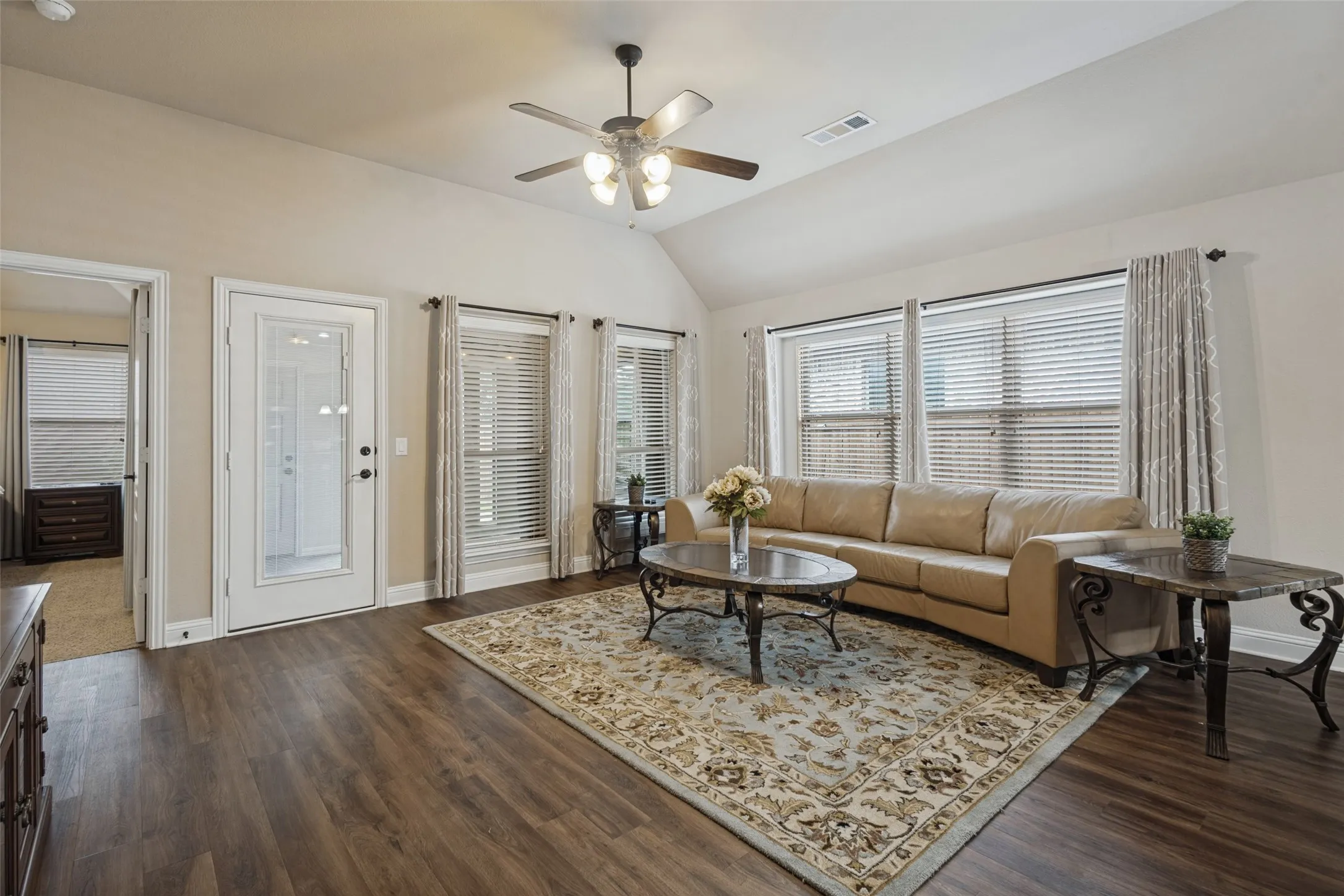 The living room is large and exits to an additional living space.