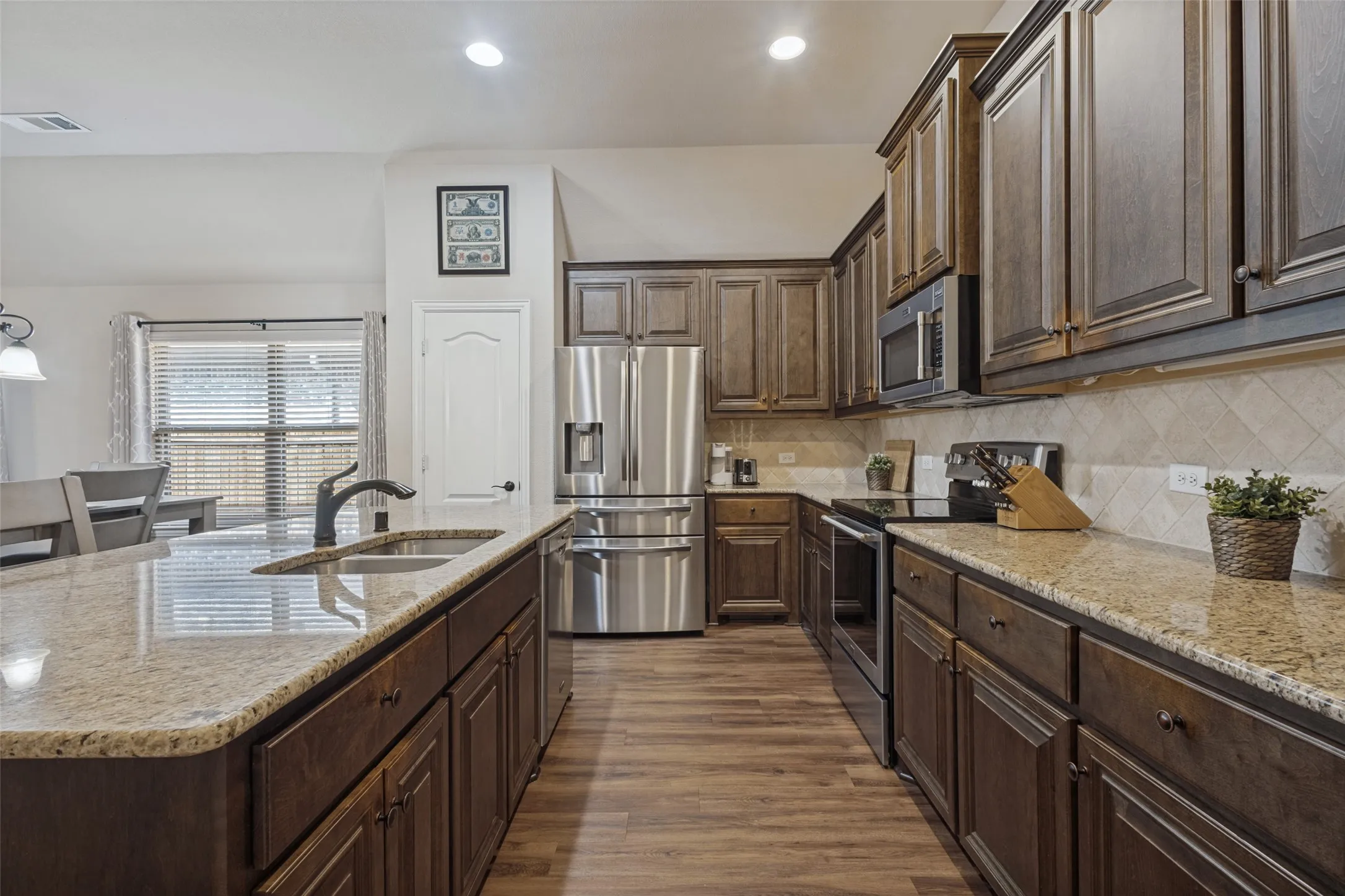 Upgraded kitchen with 42" custom cabinets, stainless steel appliances including new refrigerator, recessed lighting and granite countertops. Kitchen is also equipped with everything you will need from coffee maker to toaster, etc.
