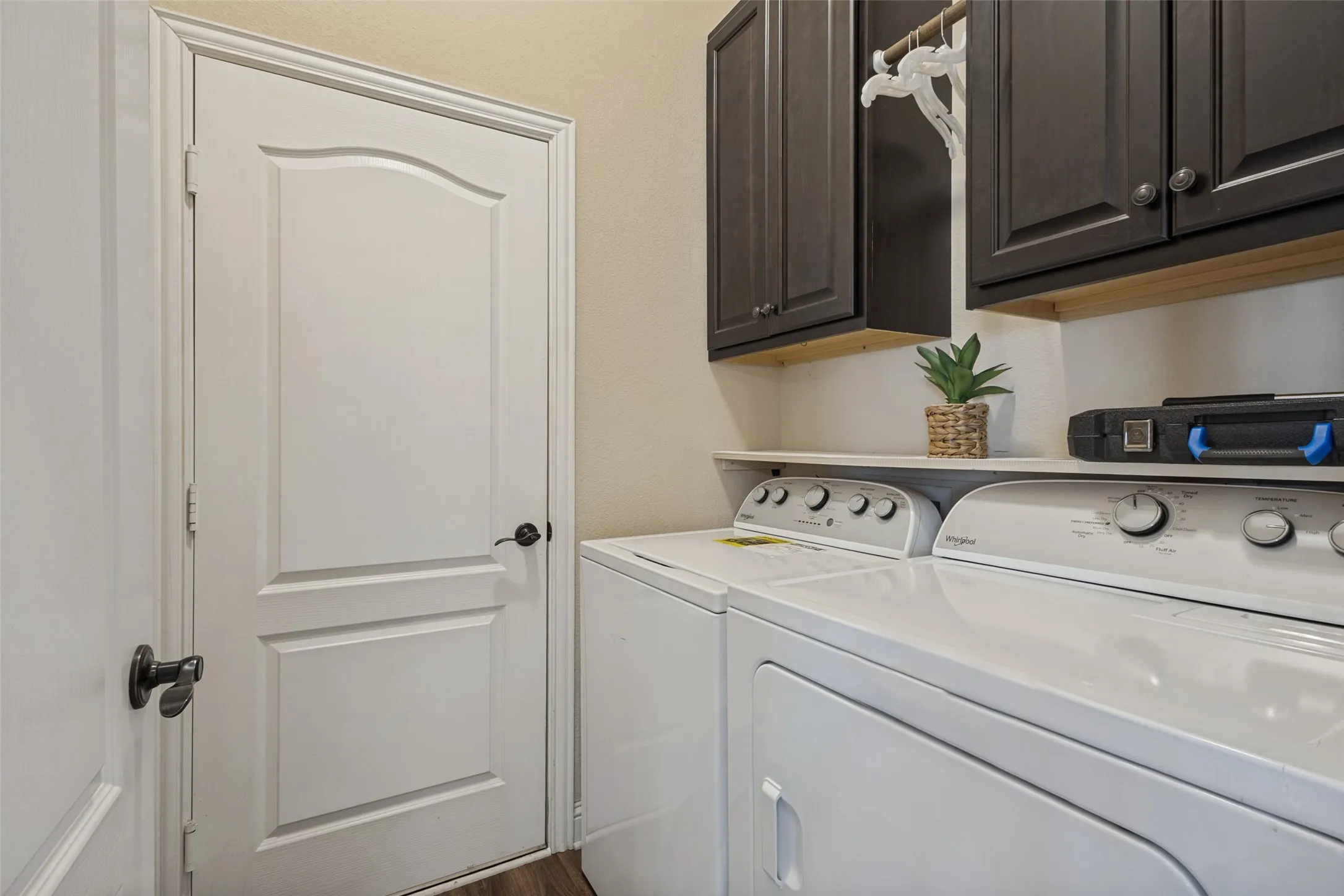 Fully equipped utility room with cabinets.