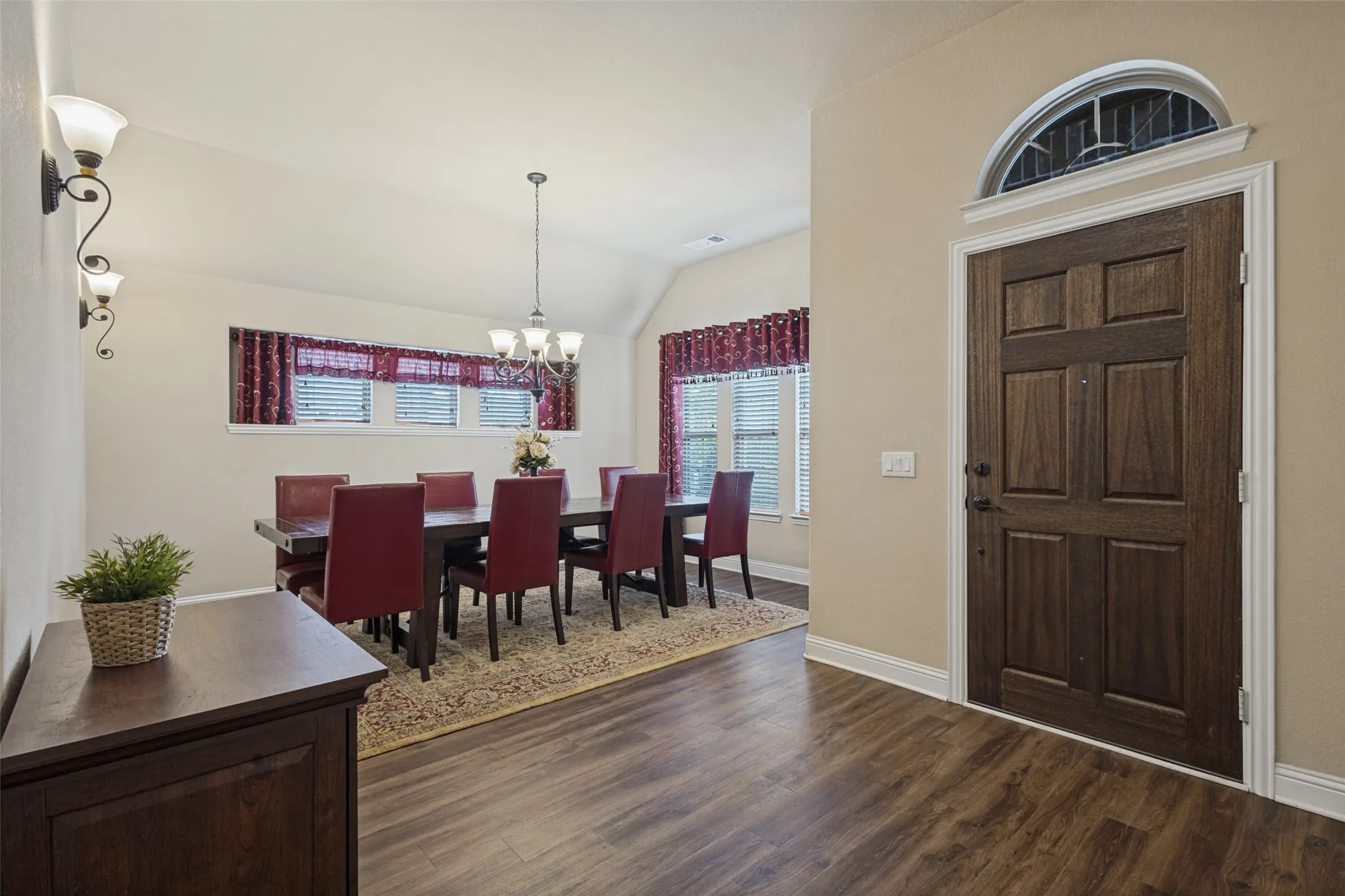 Formal dining area at front of home with a fabulous dining set and decorative lighting.