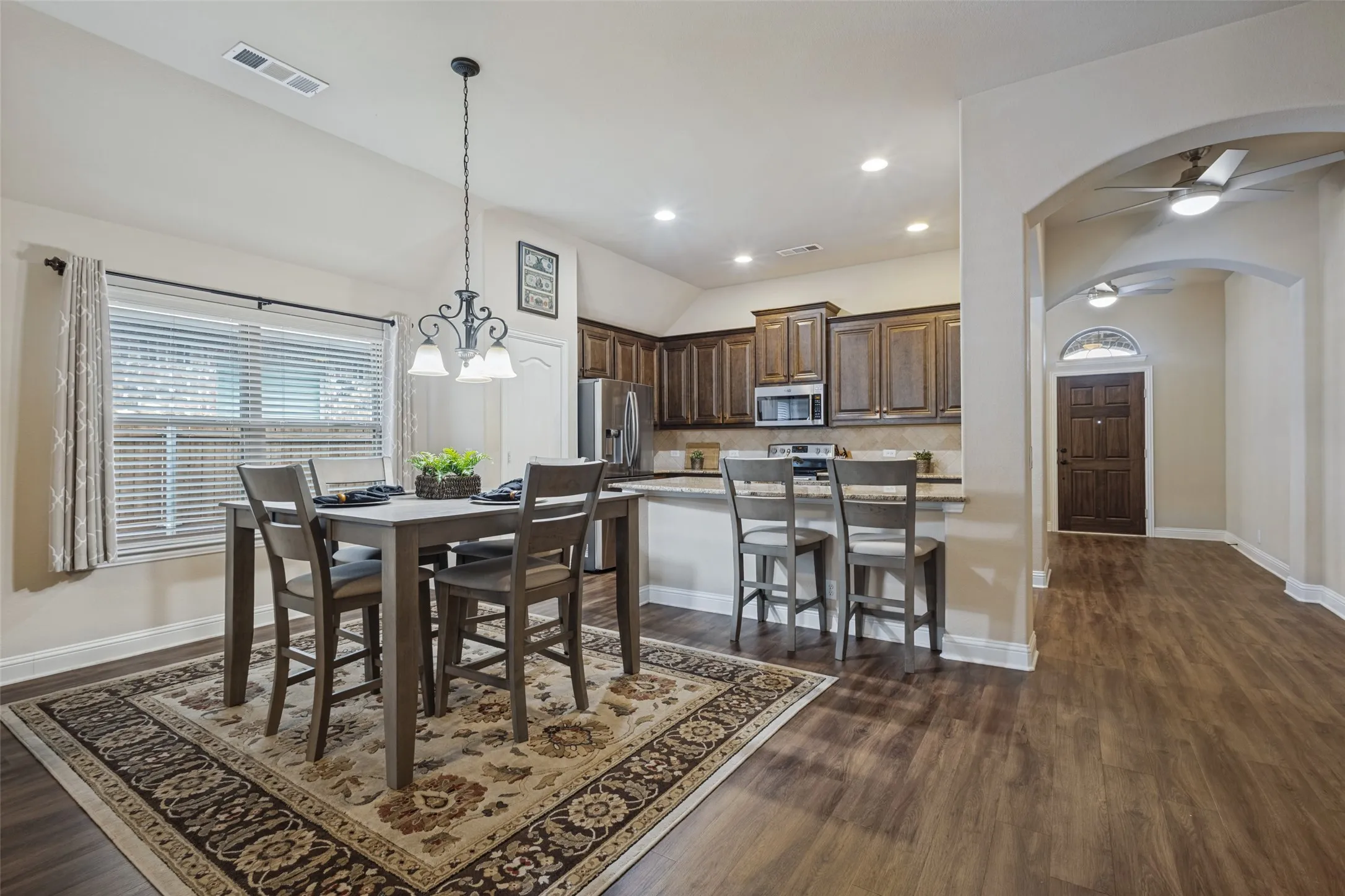 Dining area with additional breakfast bar seating.