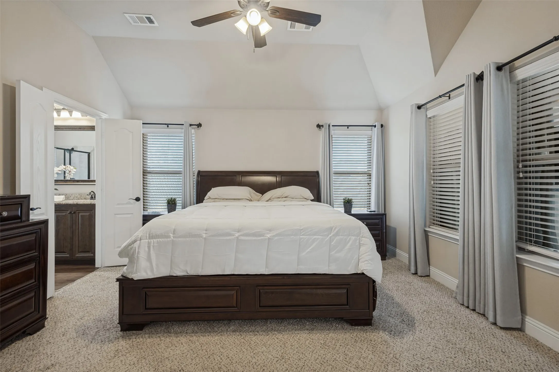 Large master bedroom with decorative ceilings and ensuite.
