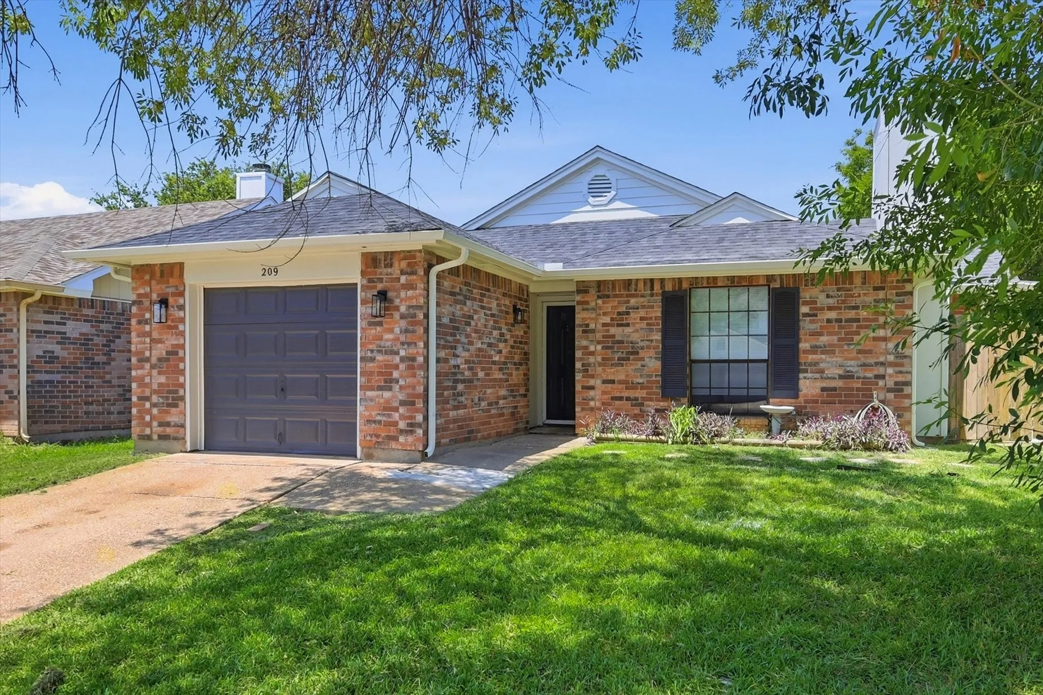 Brick exterior with dark gray garage door