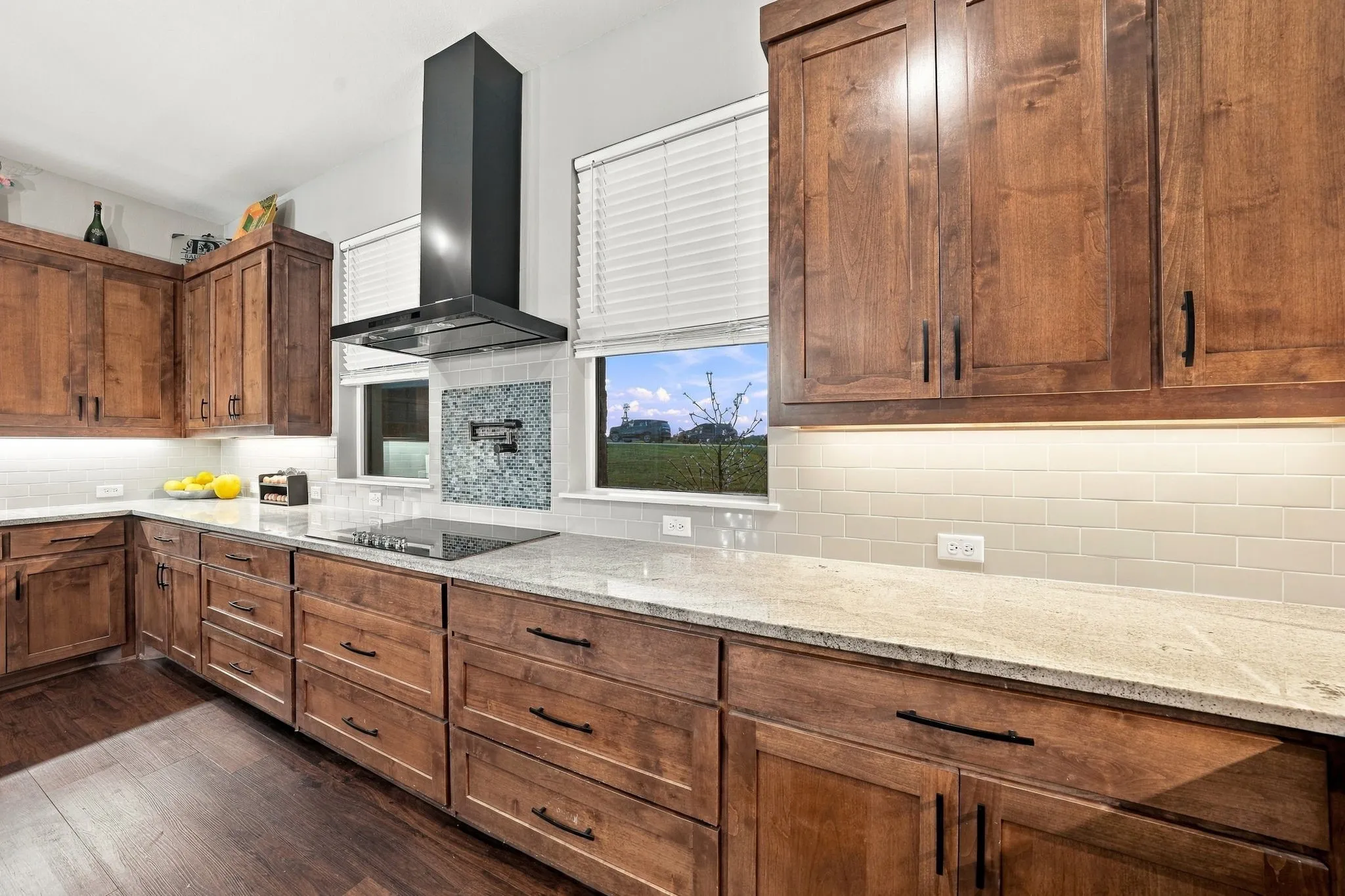 Custom kitchen cabinetry with electric stove and pot filler