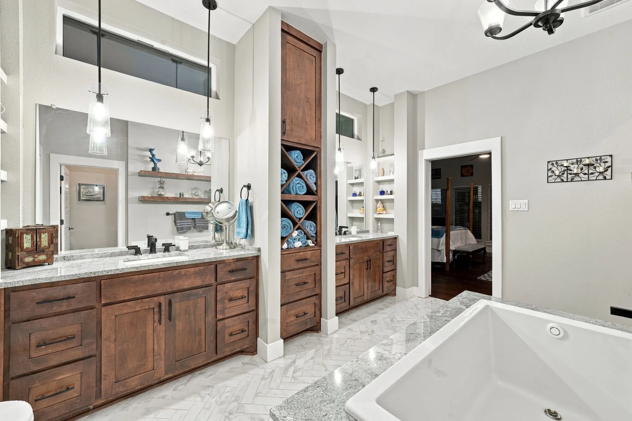 Primary bathroom with custom cabinets and dual vanities