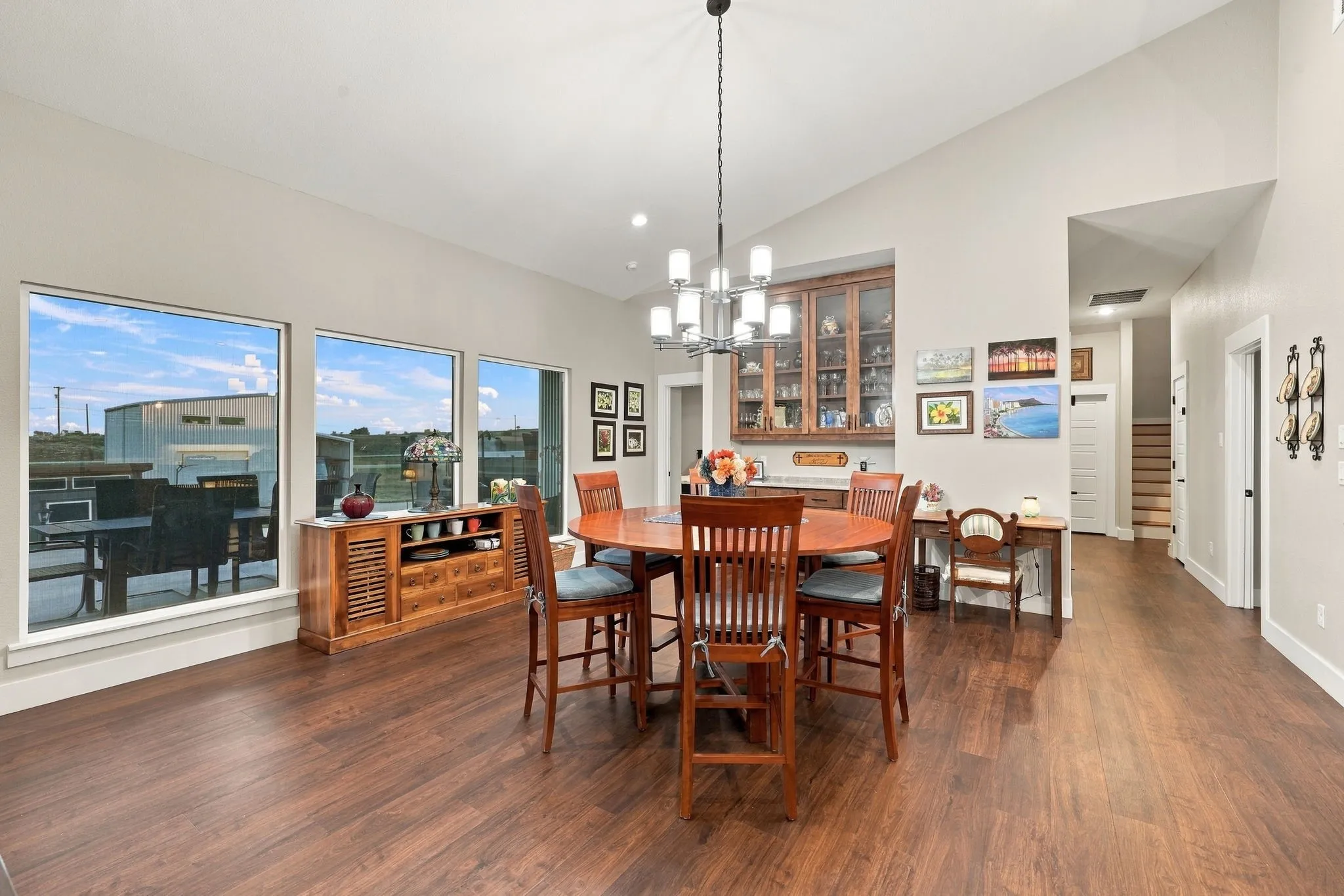 Dining area with built in cabinets and views of the spacious backyard